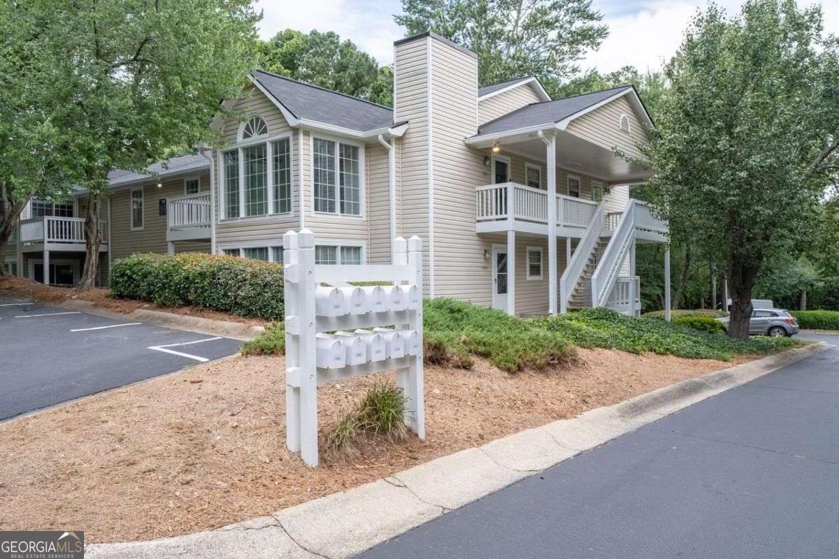 Quiet move-in ready condo, tucked in the back of the complex. Sunroom is all windows! It and the balcony overlook a peaceful wooded area. All appliances were replaced 2 years ago, except the microwave. That includes laundry and the 5-Burner Gas Range with griddle! Owner has made other updates as well, including: new carpet tile and LVT flooring, added ceiling fans with lights to both bedrooms, had under-sink plumbing replaced as well as the dryer exhaust ducting. The roof is only 5 years old; Low maintenance living for years to come! Catch some rays at the community pool and tennis court and enjoy the convenience of Smyrna without all the hustle and bustle.