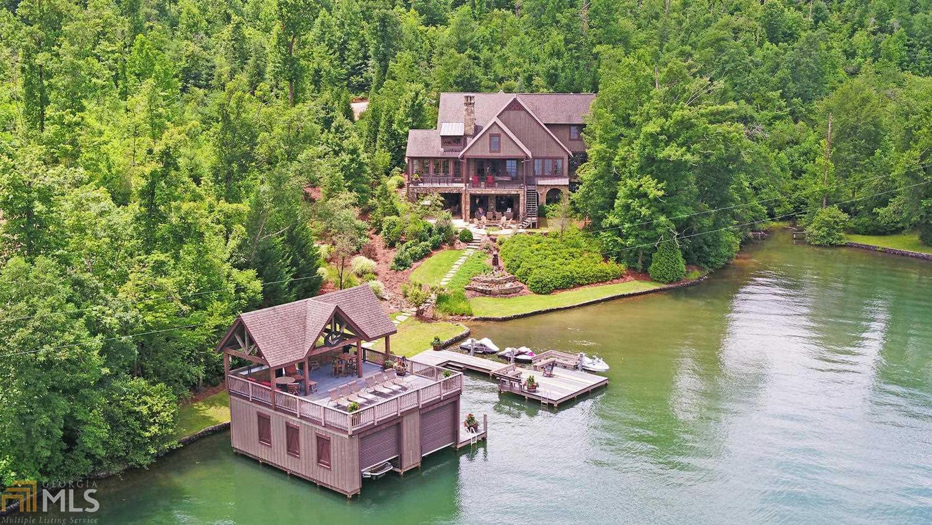 This 7BD, 5FB, 2HB custom home was designed for entertaining. Rich with character and style, the home features a warm rustic feel with antiques and reclaimed materials throughout. The main floor provides an open floor plan with vaulted ceiling, scraped walnut flooring, lake views and plenty of space to gather around the masonry stone fireplace. The gourmet kitchen includes professional appliances, copper apron front sink and large island with prep sink. A spacious sunroom with fireplace, covered porch and rocking chair deck enjoy lake and mountain views. The terrace level features a family room with masonry stone fireplace, billiards, wet bar, wine cellar and access to a generous covered patio and lakeside fire pit.