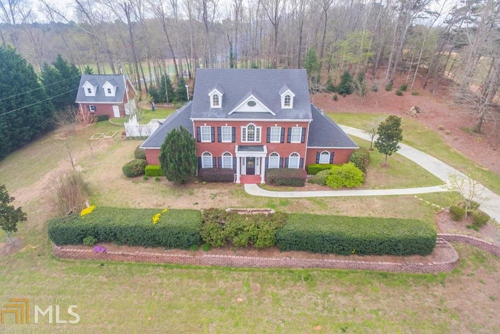 DRAMATIC PRICE IMPROVEMENT!! Beautifully framed by professional landscaping and gorgeous gardens, this stately brick home offers peace and serenity while still being close to the city. The huge, rear patio is an entertainers dream. This elegant floor plan features abundant natural light. The lovely chefs kitchen flows seamlessly into the impressive dining room & out to the patio. The family room features a fireplace, perfect for those chilly nights. Spacious master suite features a massive walk in closet and gorgeous bath. The 3, spacious, bedrooms & loft space upstairs are perfect for your growing family. The oversized attached garage provides enough room for 3 cars. The separate, detached garage provides additional workshop space & room for all your toys.