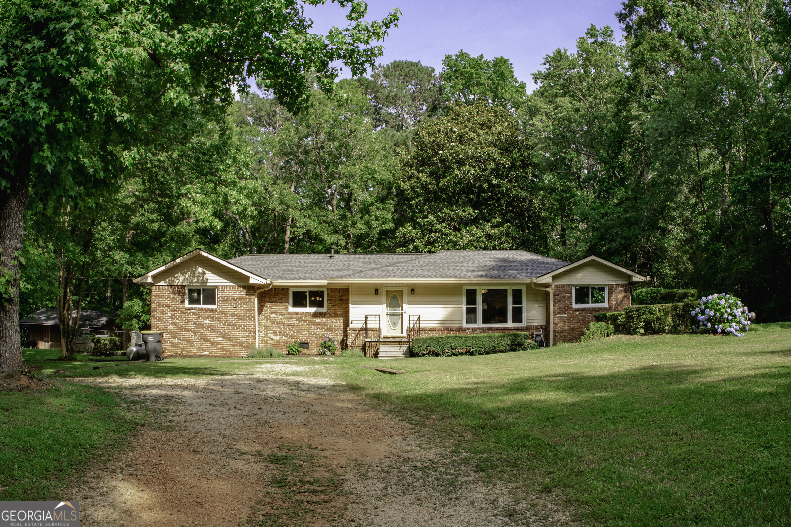 Welcome to this charming 4-Bedroom Home on over 3 Private Acres with Modern Upgrades & Space to Spare! All of the costly upgrades have been done! Welcome to your peaceful retreat! Nestled on over 3 beautiful private acres, this updated 4-bedroom, 2-bath home offers comfort, efficiency, and room to roam-inside and out, within minutes of downtown Newnan and just a 9 minute drive to 85. Step inside this beautiful brick home to discover all new luxury vinyl plank (LVP) flooring throughout the entire home, creating a seamless and modern look. The gas stove, gas hot water, and completely replaced and updated gas HVAC system ensure cozy, efficient living year-round. A new roof and energy-efficient windows (installed in 2022) mean peace of mind and lower utility bills. The primary suite features his and her separate closets and a tub and shower. Kitchen features newer stainless steel appliances and a separate breakfast nook and tons of storage and cabinet space. There is also a separate Office room on top of the 4 bedrooms! Enjoy the outdoors from your large back deck with ramp access, overlooking a huge, fenced-in backyard-perfect for pets, play, or peaceful evenings. Bring the pets, this home features a newly installed back door with a built-in doggy door. Additional features include: * A massive 4-car carport * A detached 2-car garage with its own workshop/storage room with separate entrance. * Washer/dryer hookups in the basement * A French drain system and separate basement entrance-great for future potential or extra storage. This property combines country charm with modern updates and unbeatable outdoor space. Whether you're hosting gatherings or just soaking in the quiet, this home is awaiting to fulfill your dream of peaceful living. Schedule your showing today and do not wait on the chance to make this private, move-in-ready gem your own! Contact agent for video tour link to tour this property virtually!