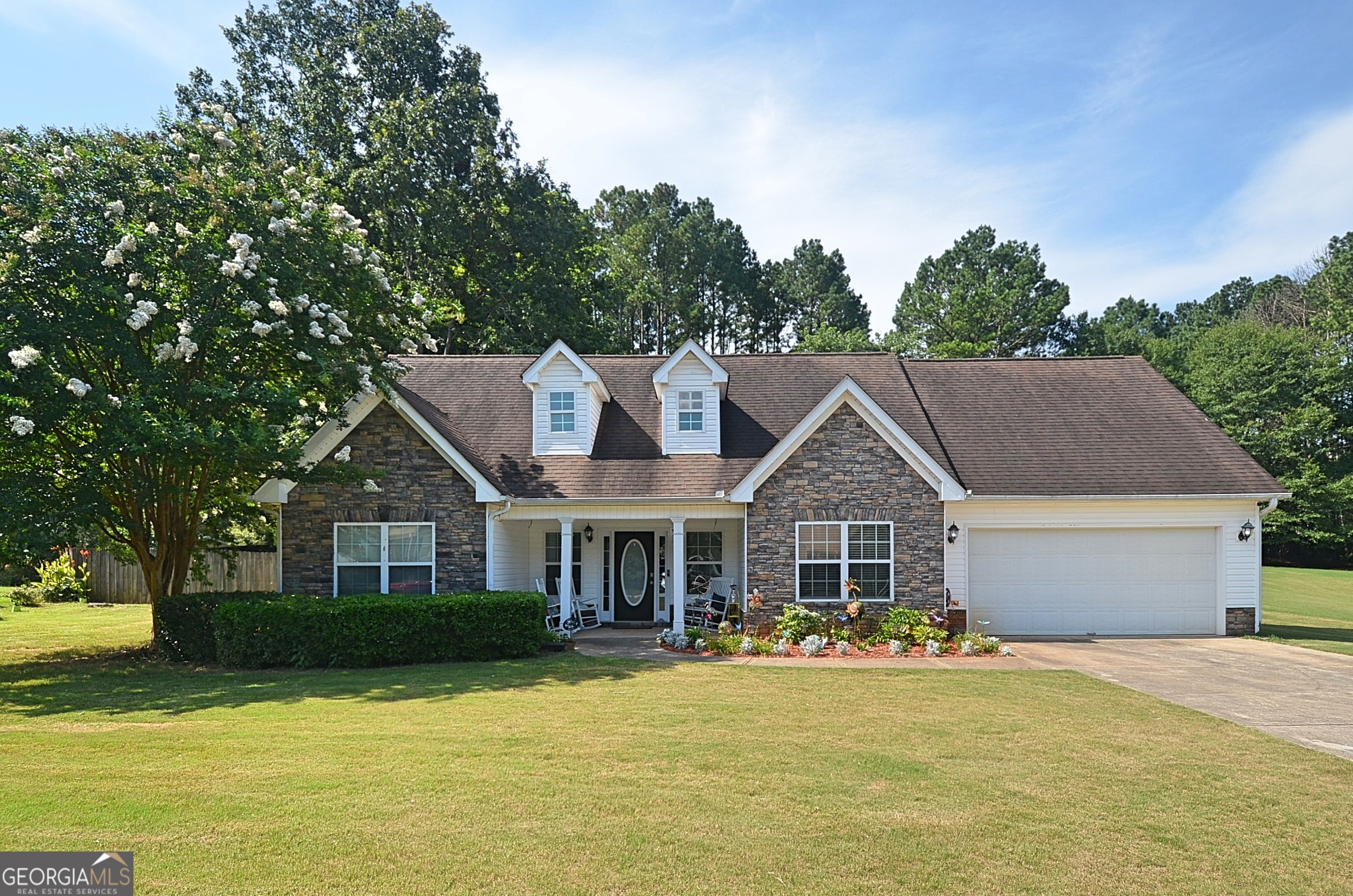 Welcome to Social Circle and to Laurel Oaks subdivision in beautiful Walton County. This neighborhood is conveniently located across from the award winning schools and close to the vibrant downtown area of Social Circle. This home has been recently updated with new LVT flooring ,new counter tops in the kitchen and paint that is so calming and beautiful. From the deep front porch with plenty of places to sit, you are welcomed into the foyer area that is spacious with 2 coat closets, a formal dining room to the right and to the left you head to the 2 secondary bedrooms and hall bathroom. From the huge vaulted ceilings and the stone fireplace in the living room you have the open concept space into the kitchen area with a bar area, cool light fixture with a fan built into it to the breakfast area. The laundry room and garage are located in this area as well. The primary bedroom is off to the back and is like your own private spa retreat area with a large closet to hold all the clothes and shoes you could want and the bathroom boasts a soaking tub, large vanity, shower and toilet. Upstairs is the bonus room which could be used as the 4th bedroom as this owner has chosen to do, as well as access to the storage area in the attic. The 2 car garage is spacious and has a nice size driveway with plenty of parking. The yard is well maintained & beautiful with plenty of space in the front and sides tent/on the front and side yards and chain link in the back. The property goes beyond the chain link in the back. A few large trees in the back provide shade and you have a covered/tent /gazebo area out the backdoor , a grilling shed to keep the hotdogs and burgers dry in case of rain, as well as an above ground pool that will be a hit for family and friends. PLUS....a huge storage shed to hold all the extras you might want or you could turn it into a party barn to make that backyard another great retreat area! Plenty of reasons to come see this beautiful home! Social Circle is growing the downtown area with lots of restaurants, shopping, banking, parks, churches, music. It's a small town with lots of charm that you may be looking for with plenty to do if you desire! Call today and let us show you this home.