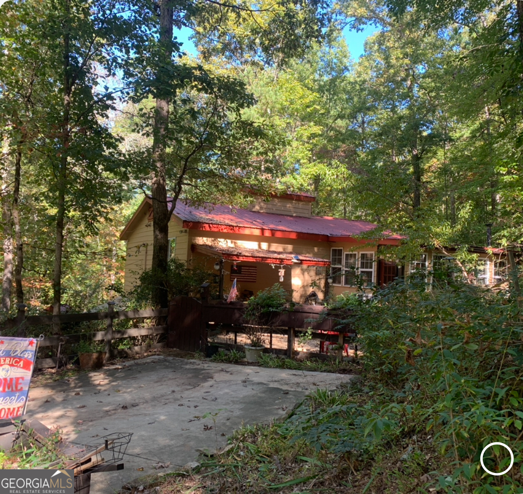 A place of peace by the stream sounds like an amazing spot to relax and unwind. Cabin has a touch of craftsmanship and a bit of country in every room. Kitchen features a small pantry and ample cabinet space. A rocking chair by the fireplace would be a great place to read the winter evenings away. Firepit and gathering spot outside are perfect for the cool evenings. Enclosed porch provides warmth on the cool mornings as you enjoy a bit of birdwatching and a hot cup of coffee. Bedrooms and sitting area on main floor are perfect for you and guests to gather before a great night's rest. Basement area features partial finished space and a nice spot for workshop including a full bath. The stream and the colorful fall leaves will remind you how easy it is to just be thankful for the natural beauty of North Georgia. Minutes from Carter's lake and great shopping in downtown Ellijay and just a few miles from the Apple house's and the Vineyard's. Welcome to the "good life". Home was filled with love for many years and is ready for the next family to smile and say " home is where the heart is". It's so good to be home.