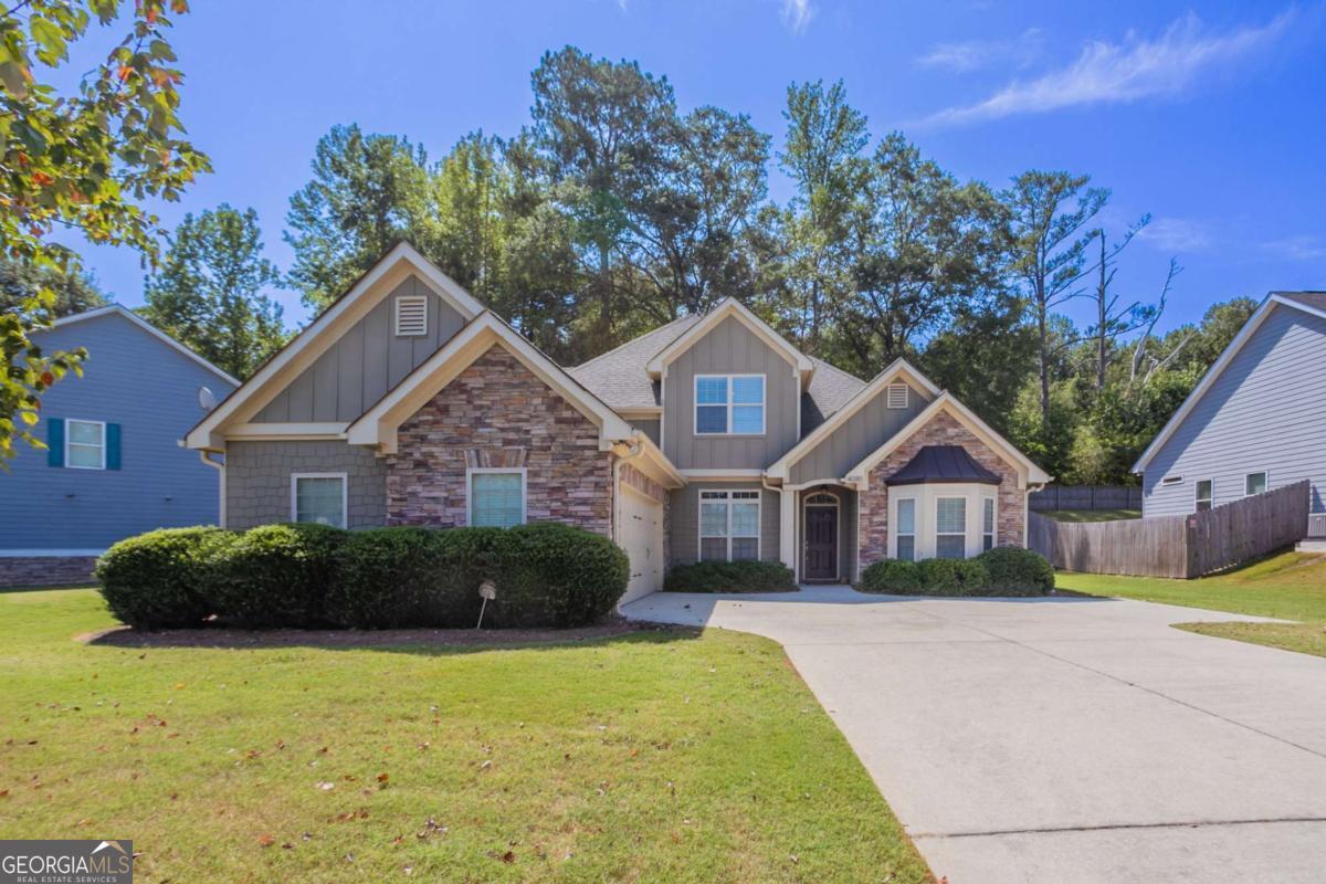 Beautiful two-story home in the desirable Stonebrook community, offering a primary suite on the main level and a spacious open floor plan. The family room features a cozy corner fireplace and connects seamlessly to the kitchen with stained cabinets, pantry, and breakfast bar. The main-level primary suite includes double vanities, a whirlpool tub, and a separate shower, while the upstairs bedrooms provide privacy and flexibility with their own full bath. Enjoy outdoor living on the covered grilling porch with ceiling fan, perfect for year-round relaxation. Neighborhood amenities include sidewalks, playground, pool, tennis courts, and street lights. Conveniently located near shopping, dining, and major highways, this home combines comfort and community living.