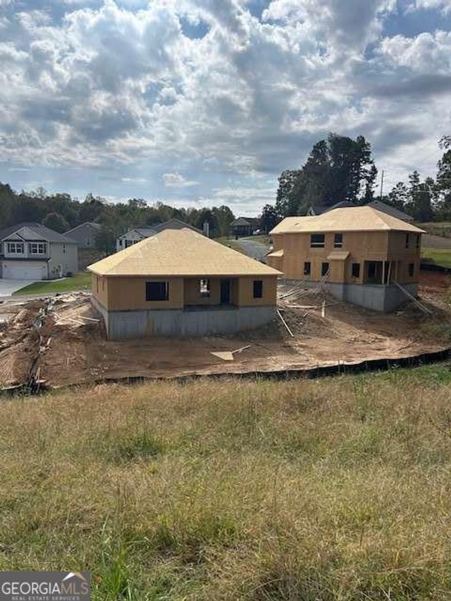 Under Construction!! Welcome to Adams Homes' popular ranch-style plan The 1709 Ranch - Where Comfort Meets Quality  Come see the Model home and get a feel for what your new home will look like.   Discover effortless one-level living in this beautifully designed 3-bedroom, 2-bath ranch home on a slab foundation. Enjoy an inviting open floor plan that blends the kitchen, dining, and family areas seamlessly-perfect for entertaining or everyday living. The kitchen features an extra-large island, ideal for meal prep, casual dining, or gathering with friends.  The spacious family room showcases an electric fireplace, adding warmth and charm to the heart of the home. The owner's suite offers a touch of luxury with a separate soaking tub and shower, a transom window above the garden tub for natural light, and a generous walk-in closet.  Step outside to the covered lanai with ceiling fan, the perfect spot to relax and unwind. Luxury vinyl plank flooring enhances the main living areas, while soft carpet adds comfort in the bedrooms.  Includes a 1-year builder warranty, 2-year systems warranty, and 10-year structural warranty for added peace of mind. Low-maintenance HOA and nearby shopping and dining make this the perfect place to call home.    This new construction home combines modern convenience, timeless design, and unbeatable value.  Excellent opportunity - excellent price! Don't miss out on this one!