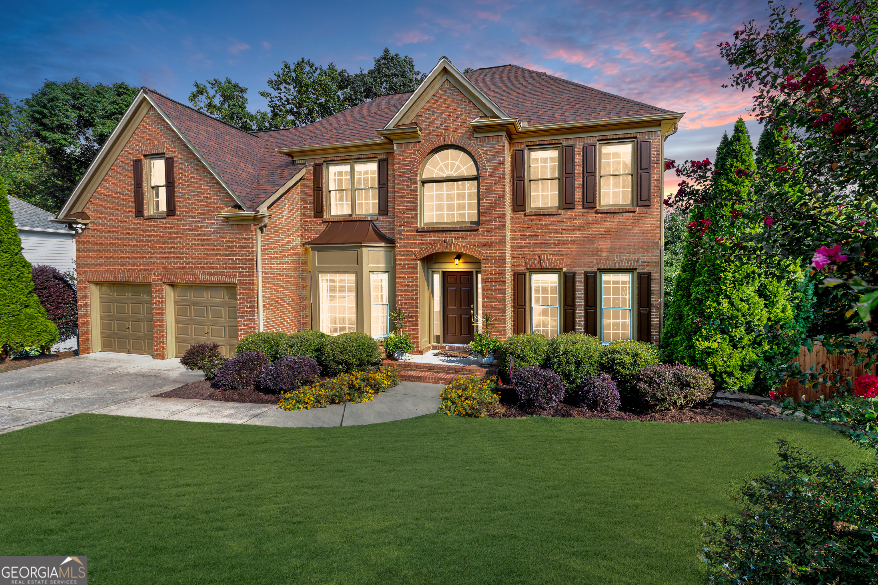 Come HOME to this 5-Bedroom, 4-Bath, Brick-front Beauty! Located in Morningview in the heart of Suwanee, one of Georgia's most desirable cities, this home offers the perfect blend of space, style, and community living. Step inside the grand two-story foyer with hardwood floors throughout the main level and enjoy elegant formal spaces including a separate dining room and living room/office alongside an open-concept design ideal for today's lifestyle. The kitchen is a chef's delight with solid surface countertops, new stainless-steel appliances, a center island, and custom walk-in pantry- flowing seamlessly into the sunny breakfast nook and fireside family room, where soaring ceilings and floor-to-ceiling windows showcase stunning wooded views. Just off the kitchen, step onto the deck to enjoy a private retreat that borders Suwanee Creek- offering a serene escape surrounded by natural beauty, wildlife, and songbirds. A beautifully designed bedroom and half bathroom complete the main level. Upstairs, retreat to the oversized primary suite featuring a tray ceiling, dual custom walk-in closets, and a newly renovated spa-like bath with an elegant centerpiece free-standing tub, beautifully tiled oversized glass shower, and double vanities. Secondary bedrooms are equally spacious, with private and shared bath options designed for comfort and convenience. The unfinished basement, stubbed for bathroom, offers incredible potential for future expansion, while the leveled, lush green backyard space offers the perfect setting for entertaining, playing, or soaking in the peaceful natural beauty. Living in Morningview means more than just a home-you'll enjoy resort-style amenities including multiple pools (junior Olympic with water slide, splash pad, and quiet pool), tennis and pickleball courts, sand volleyball, playgrounds, clubhouse, trails to Ivy Creek Greenway and George Pierce Park, community green spaces, sidewalk-lined streets, and a calendar full of neighborhood events. Minutes from Suwanee Town Center, the Mall of Georgia, I-85, and zoned for the award-winning North Gwinnett school district - including Suwanee Elementary, North Gwinnett Middle, and North Gwinnett High School. Your Suwanee Retreat Awaits. Welcome Home!