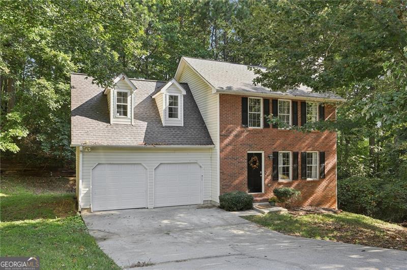 This home is perfect for your family's next chapter in Atlanta's Sandalwood Estate, nestled in a quiet culdesac in a great neighborhood. This beautifully maintained traditional home has hardwood floors on the main floor and provides all the space and comfort you need with 4 bedrooms, 2 full baths, and 1 half bath. The home's 2,156 square feet includes an unfinished basement, waiting for someone to convert it into a playroom, media room, home office or man cave. The heart of the home is a welcoming family room, complete with a cozy fireplace adjacent to a large dining room with judges panels -ideal for casual or elegant gatherings this holiday season. Step outside to a nice wood deck off the kitchen facing a secluded wood line, ready for everything from al fresco dinners to weekend barbecues, making outdoor entertaining super cozy. With a two-car garage, you'll have plenty of space for family vehicles and extra storage. This home is the perfect blend of practical features and family-friendly space. It's an opportunity you won't want to miss.