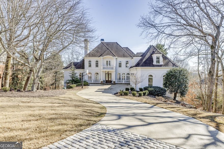 Located on a 1.27-acre sprawling lot on one of the most prestigious streets in Country Club of the South, this home offers a spacious layout with multiple indoor and outdoor living areas. The property features two full-length decks overlooking the pool and gazebo, providing ample outdoor space for relaxation. The two-story great room is filled with natural light from floor-to-ceiling windows and has direct access to the upper deck. The kitchen is equipped with custom white cabinetry, granite countertops, and high-end appliances, and it opens to a fireside keeping room. The main-level master suite includes a fireplace, a large His/Hers walk-in closet, private veranda access, and an en-suite bath with dual vanities, a soaking tub, and a separate shower. Secondary bedrooms are all en-suite, offering private bathrooms and spacious layouts. The terrace level is designed for entertaining, featuring a mahogany bar with granite countertops, a media area, an exercise room, a pool and game area, a bedroom, and two full baths. This level opens onto the lower veranda, which leads directly to the pool area. The backyard is fenced  and  offers natural privacy. Additional features include a 3-car garage, and hard coat stucco construction. This property is being sold as-is. Country Club of the South offers 24/7 gated security, a Jack Nicklaus designed golf course, tennis courts, parks, a clubhouse, and community amenities. Don't miss the opportunity to own a property in one of the most exclusive communities that epitomizes sophistication and tranquility.