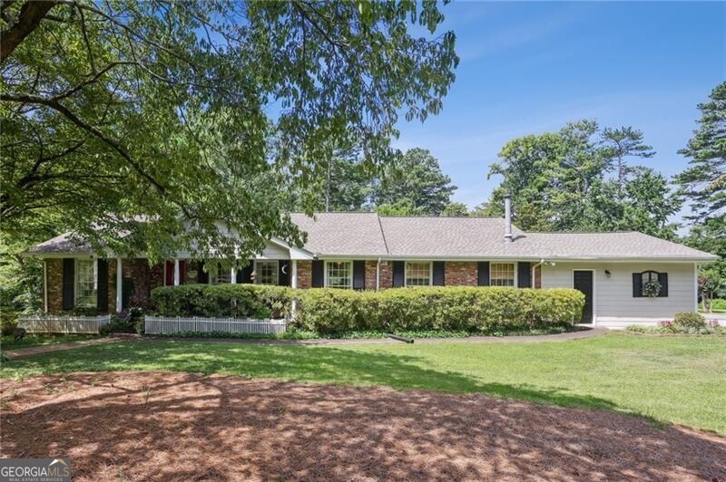 SUPERB 4 sided brick ranch in West Side Elementary School district and easy access to Kennestone Hospital and The Walker School! GORGEOUSLY landscaped almost 1 acre corner lot on a private street. Renovated kitchen with two toned cabinets and stainless appliance package. TONS of living space including a living room, a huge sunroom on the back AND a huge den with wetbar. Partial basement that is unfinished and perfect for storage. Newer roof, 2 car side-entry garage, custom koi pond, real oak hardwoods throughout, and a deck on the rear.
