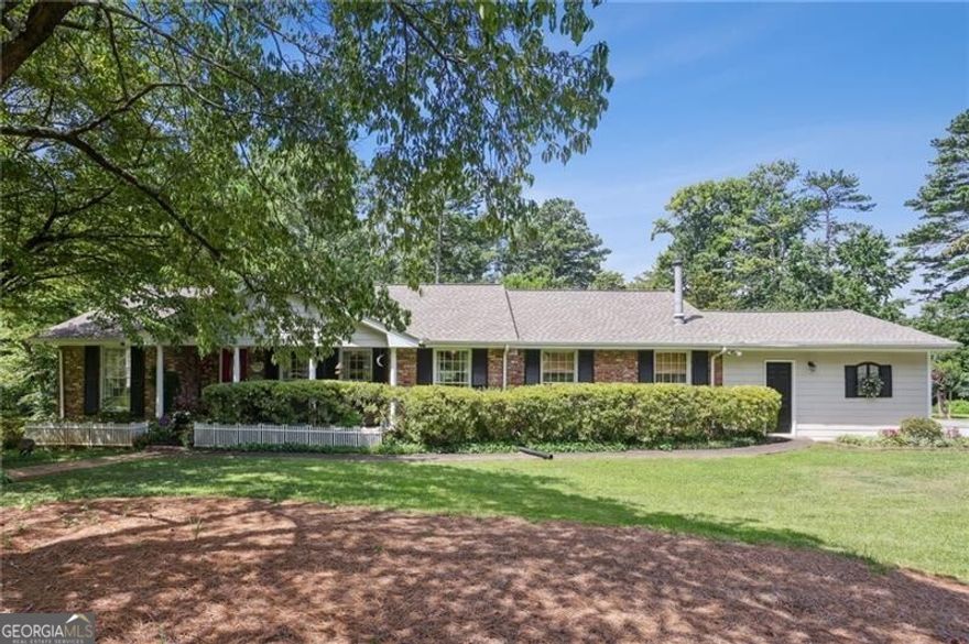 SUPERB 4 sided brick ranch in West Side Elementary School district and easy access to Kennestone Hospital and The Walker School! GORGEOUSLY landscaped almost 1 acre corner lot on a private street.  Renovated kitchen  with two toned cabinets and stainless appliance package.  TONS of living space including a living room, a huge sunroom on the back AND a huge den with wetbar. Partial basement that is unfinished and perfect for storage.  Newer roof, 2 car side-entry garage, custom koi pond, real oak hardwoods throughout, and a deck on the rear.