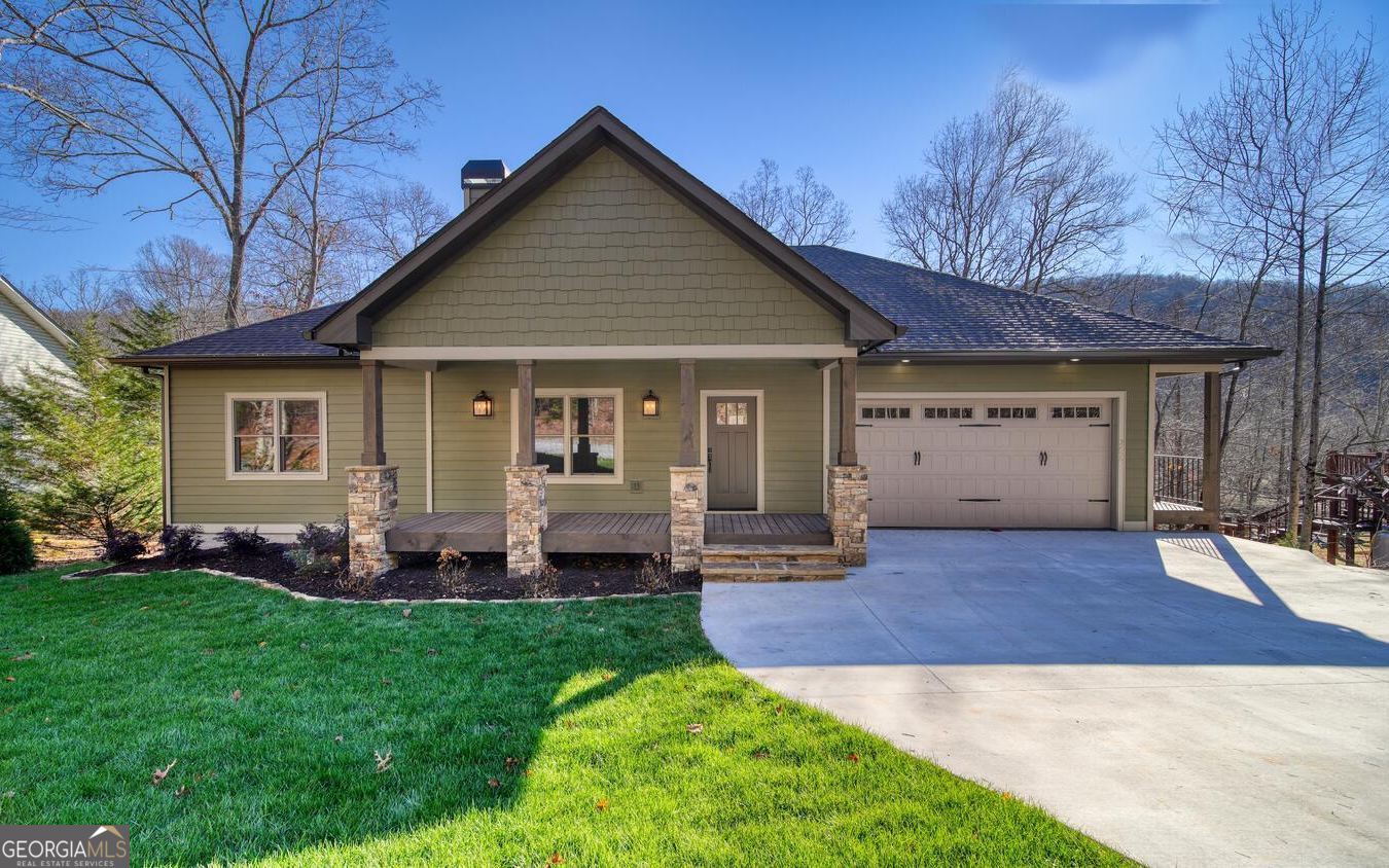 Almost new home with high end finishes. Furnished. Great Room with wet bar, two fireplaces, huge covered porch, real sanded wood floors, granite counters in kitchen and baths, hardi board siding, concrete driveway, beautiful landscaping and sod, bonus room, and 4-bedroom septic system. All overlooking a large flat yard and Lake Chatuge. Home is on the upper end of the lake where it joins the river. It is seasonal docking for larger boats and pontoons but smaller boats and kayaks could navigate it year-round. When the lake level is down, the home is still on a fast flowing river. Dock permit was issued to Builder (see Permit in Documents).
