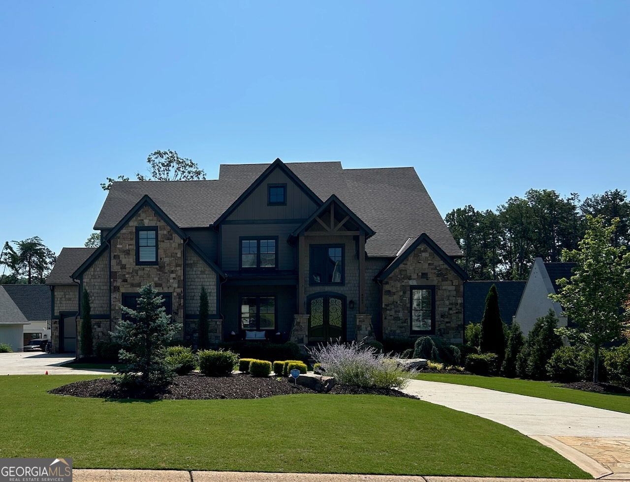 Executive home in gated Swim/Tennis Lake Community. Live the Lake Life in Luxurious Hickory Lakeside * This stunning, custom-designed home in the coveted HICKORY LAKESIDE community on LAKE LANIER, offers a rare opportunity to own a piece of paradise. Nestled in Forsyth County's Top-Rated School District, this home seamlessly blends the serenity of lake life with modern conveniences. * Imagine waking up to the tranquil ambiance of the lake, then spending your days enjoying the great outdoors right at your doorstep. This home even includes a COVERED, SINGLE SLIP on one of the three community docks, perfect for launching your boat and exploring the vibrant waters. * Inside, discover a haven of modern luxury. The main level boasts a spacious primary suite with an oversized dual closets plus a main level study, chef's kitchen with keeping room and a fabulous screened porch. Upper level features 3 spacious bedrooms room with ensuite bathrooms and walk in closets. Thoughtful design extends to the everyday conveniences. Organize your belongings with ease in the dedicated mudroom and whip up culinary masterpieces in the gourmet kitchen featuring a stunning quartz island. Premium appliances elevate your cooking experience as well as the soft-close custom cabinetry and a pot filler. Terrace level finished with theater room, recreation area and bedroom with full bathroom. Home generator included. Beyond the walls of your home, a vibrant community awaits. The neighborhood boasts top-notch amenities like a pool, tennis and pickleball courts, a clubhouse, and three community docks with golf cart parking. Enjoy gatherings with friends and family by the lakeside firepit, creating memories that will last a lifetime. * DON'T MISS THIS CHANCE TO OWN A PIECE OF LAKEFRONT PARADISE! Schedule a showing today to learn more about this fabulous opportunity.