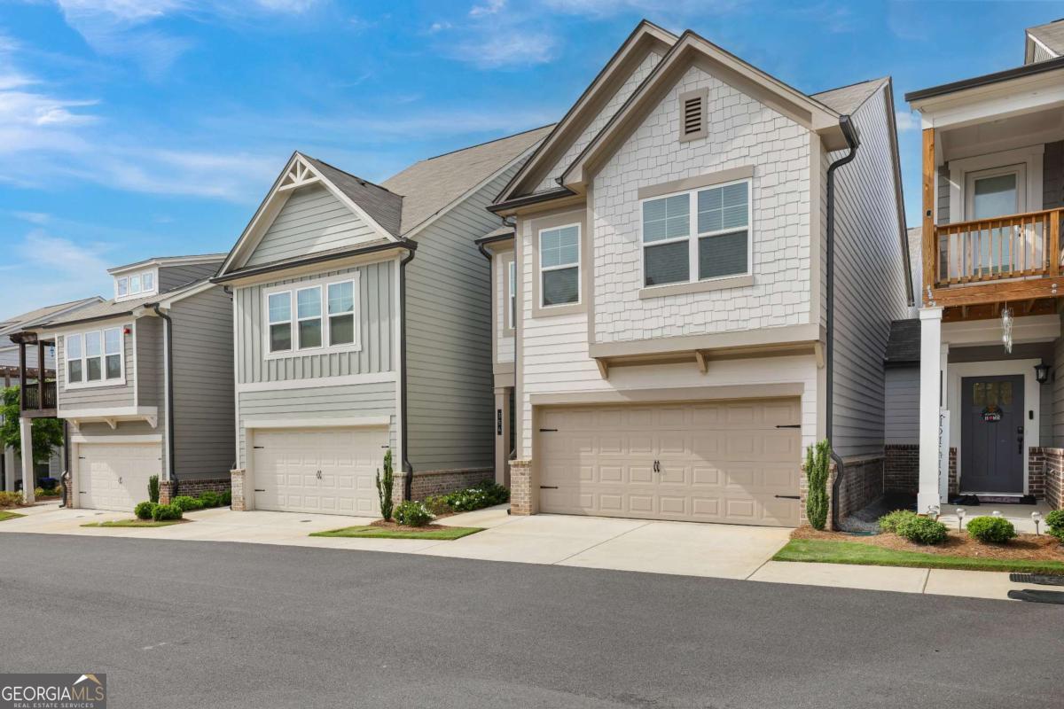 Ask us about a $7,000 grant toward your down payment and $1,000 toward closing costs with our preferred lender (no obligation to use). Discover effortless living in this beautifully upgraded townhome, where style, comfort, and convenience come together. Say goodbye to yard work and hello to more free time with low-maintenance living. The chef's kitchen features sleek quartz countertops, a large island, and high-end appliances-perfect for both everyday meals and entertaining. The open-concept living area offers a cozy fireplace flanked by custom built-ins, adding charm and functionality. Upstairs, the spacious primary suite is a true retreat with an oversized walk-in closet and a spa-like en-suite bath. Two additional bedrooms offer flexibility for guests, a home office, or whatever fits your lifestyle. All upstairs bathrooms include double vanities for added comfort. Enjoy over $30,000 in builder upgrades, including hardwood stairs with modern handrails, a practical mudroom, and additional attic storage. The back patio is ideal for relaxing or hosting friends. Located just minutes from Historic Downtown Woodstock, Target, Home Depot, Lowe's, I-575, and Hwy 92-this home offers unbeatable access to shopping, dining, parks, and more. Experience the perfect blend of thoughtful design and low-maintenance living-freeing you up to enjoy what matters most.