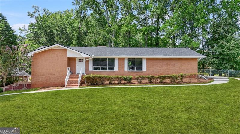 **Spacious 5-Bedroom Ranch on Finished Basement | Newton Plantation | $395,000** Welcome to this beautifully updated 4-sided brick ranch nestled on a private, level corner lot in the desirable Newton Plantation community of Fayetteville, GA. Offering incredible space, flexibility, and income potential, this home is perfect for multi-generational living or savvy homeowners looking to offset their mortgage. Step inside to find **new flooring**, **fresh paint**, and a **brand-new HVAC system**, making this move-in ready home both stylish and worry-free. The main level features a **spacious master suite**, **3 additional bedrooms**, and **2 full bathrooms**, along with a formal **living room**, **dining room**, **family room with fireplace**, and a bright **sunroom** perfect for relaxing. The **updated kitchen** boasts **granite countertops**, **white cabinetry**, and a cozy **breakfast area** that opens to the family room. A convenient **laundry room** and a **2-car garage** complete the main level. Downstairs, the **finished basement** offers incredible potential with a **private entrance and separate driveway**, **garage**, a large **living area with fireplace**, **bedroom with walk-in closet**, **full bathroom**, and a **bar area with sink** that could easily be converted to a full kitchen - ideal for use as a rental, in-law suite, or guest retreat. Outside, enjoy a **fenced backyard** perfect for pets or play. This well-maintained home offers the perfect blend of comfort, functionality, and flexibility-all in a peaceful neighborhood with no HOA. Don't miss this rare opportunity-schedule your private tour today and discover all the possibilities this home has to offer!