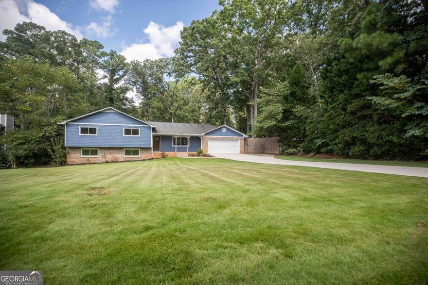 Welcome to 2961 Connie Street, a charming split-level home nestled in the highly sought-after Rolling Acres neighborhood of East Cobb. This well-maintained residence offers 5 bedrooms and 3 full bathrooms, with generous living spaces that include a large family room featuring a cozy brick fireplace. The spacious gourmet kitchen is filled with natural light and opens to a separate dining room with a bay window overlooking the private, fenced backyard. Downstairs, a finished basement provides additional living space-perfect for a rec room, office, or guest area. The combination mud & laundry room with exterior entry is the perfect place to drop shoes, bags, and laundry without dirtying the house! Not to mention the electrical, HVAC, and plumbing have all been redone and inspected!     Outside, the home boasts a beautifully landscaped yard, a patio, and a firepit-ideal for outdoor entertaining or peaceful evenings at home. Rolling Acres is a well-established community, offering residents access to neighborhood amenities and a welcoming, close-knit feel. Located within walking distance of the top-rated Pope High School district and minutes from parks, shopping, and restaurants, this home combines comfort, location, and lifestyle. Don't miss this opportunity to live in one of Marietta's most desirable communities.