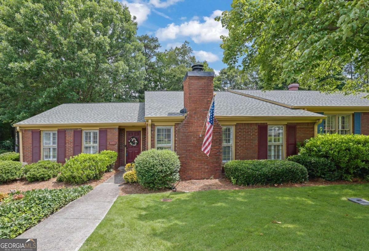 Welcome to 6423 Deerings Lane in desirable Peachtree Corners! This corner end-unit townhome features 2 spacious bedrooms, 2 full bathrooms, and a versatile den with a cozy fireplace perfect for relaxing or working from home. You'll love the inviting layout with a bright kitchen, dedicated dining area, and comfortable living space. The primary bathroom includes handicap-accessible features such as grab bars, a raised toilet, and a step-in tub. The entire interior has been freshly painted and professionally cleaned from top to bottom, including carpets, making this home truly move-in ready. Enjoy your private fenced courtyard with a covered walkway that leads directly to your enclosed 2-car garage. This well-cared-for gem is ready for its new owners! *Please remove shoes or wear shoe covering when entering the home*