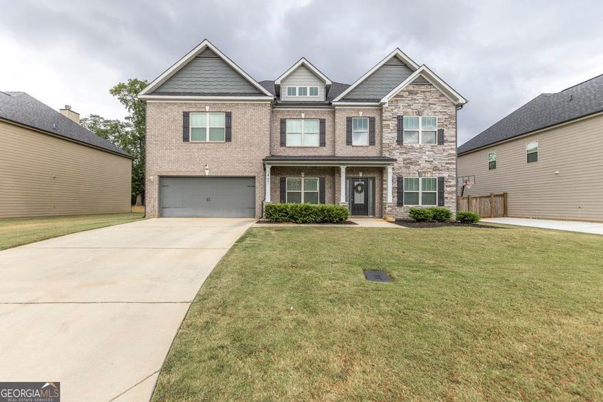 Welcome to 407 Doraville Court, a beautifully designed residence offering 4,188 square feet of thoughtfully planned living space in the picturesque Woodbury Subdivision of Warner Robins.      From the moment you arrive, the stone-and-brick exterior, inviting front porch, and manicured lawn set the stage for the elegance found inside. Step through the front door into a bright two-story foyer that opens into flexible spaces ideal for work, entertaining, or relaxation. French doors lead to a private office or gym, while the formal dining room features wainscoting and a tray ceiling that elevates every gathering.    At the heart of the home is an open-concept great room, centered by a fireplace and seamlessly connected to the chef's kitchen. Here, an oversized island anchors the space, surrounded by granite countertops, stainless steel appliances, and ample cabinetry. A stylish breakfast area and shiplap accent wall create warmth and character, while wide windows keep the space filled with natural light.    With six bedrooms and four full bathrooms, the layout offers both comfort and flexibility. Two of the guest bedrooms (one upstairs and one downstairs) include private baths, making them ideal for multi-generational living or private guest suites. The expansive primary suite is a retreat in itself, complete with a sitting area, tray ceiling, and spa-inspired bath featuring dual vanities and an impressive double shower with dual showerheads and bench seating.    Outdoor living is just as impressive. A screened-in porch with a stone fireplace and TV mount extends your living space year-round, overlooking the backyard with plenty of room for play, gardening, or entertaining.    Every detail of this home has been carefully designed for ease, beauty, and functionality, offering ample space to spread out, gather, and create lasting memories.