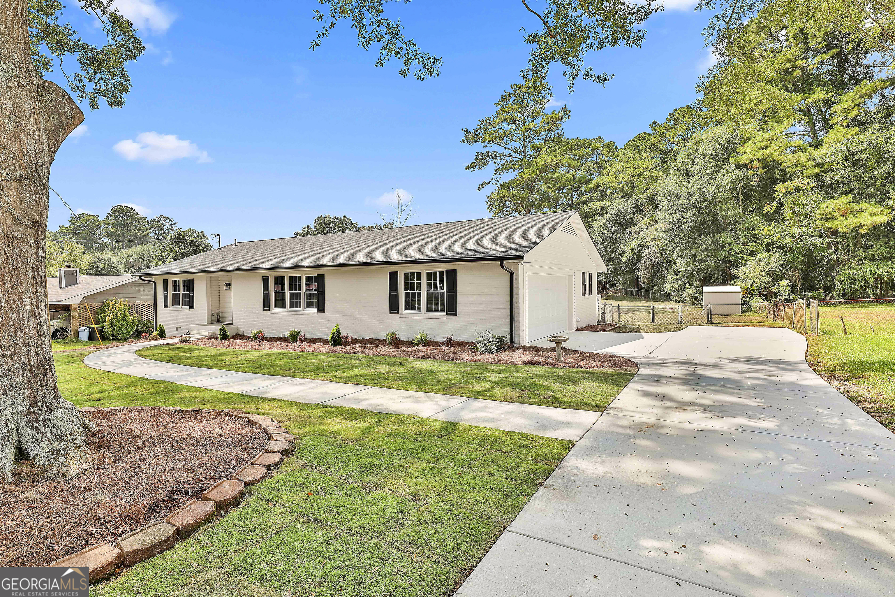 WOW! EVERYTHING IS NEW IN THIS BEAUTIFUL UPDATED RANCH HOME - EXCEPT THE REFINISHED ORIGINAL HARDWOODS! You'll appreciate the practical but beautiful 'redesign' of floorplan offering convenient Barn Doors, craftsman moldings, wide Foyer & huge open Kitchen w/ NEW center Island (dbl cabinets on each side). The light granite counters paired w/ grey/blue backsplash, white cabinets + open industrial shelving offers a fresh farmhouse look. The NEW SS exterior Vent hood gives a modern touch over the 5 burner gas stove stove. Bright window over sink overlooks the deep 'double lot' backyard. Pantry & lg Laundry rm w/ cabinet, shelving, W & D + new dryer vent to outside + NEW aluminum pull down attic stairs. Lg Dining rm off Kitchen w/ cool light fixture. Dining & Family rm both OPEN TO KITCHEN! Spacious Family rm w/ NEW fans & electric outlet on wall perfect for TV. Updated Bathrms w/ Moen fixtures, cool look lights, mirrors & vanities w/ granite + efficient comfort height dbl flush toilets. Primary bathrm offers NEW tiled Shower & Farmhouse industrial shelving. Step out back to the NEWly refurbished expansive Deck w/ stairs to below... enough rm to enjoy a bbq gathering with all the family. 2 car side entry Garage w/ NEW Garage Door & NEW Opener. NEW long Driveway, extended Parking Pad & Sidewalk to front door. All NEW Landscaping & sod in front area + limbs were trimmed back on the gorgeous mature trees in front. Lush, big, fenced backyard has dbl gates for easy access. 19' x 19' Workshop w/ built-in benches & electrical/sub panel is ready for all your hobbies & has RV Power & water hookup close by + 7' x 9' outbuilding for all your lawn tools. Even More... NEW Roof, NEWer Furnace, NEW AC, NEW thermal efficient Windows, NEWer Hot Water Htr, Septic just Pumped & Inspected, NEW Termite Bond, NEW Attic insulation, NEW 'Smart Key' locks & NEW vapor Barrier in Crawlspace. Most plumbing/fixtures/pipes/wiring/switches & outlets have been replaced. This home is truly 'Move In Ready' & I don't think anything was missed! Listing Agent holds a GA RE license & is part owner. Quiet street w/ quick access to Shops/Restaurants of Ashley Park, I-85, Atlanta & Airport.