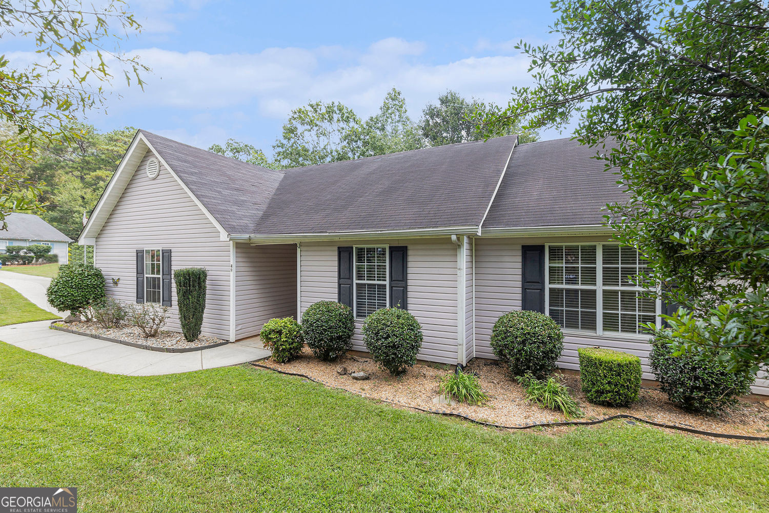 Welcome to this beautiful ranch-style home nestled in a quiet, well-established neighborhood in the heart of Newnan. Situated on a spacious corner lot, 49 Virginia Heights Drive offers both privacy and convenience, just minutes from downtown Newnan, Ashley Park, Piedmont Newnan Hospital, and easy access to I-85. This thoughtfully designed home features an open floorplan with seamless flow and durable laminate flooring throughout. The large, sun-filled kitchen boasts abundant natural light, ample counter space, and cabinetry, perfect for cooking, entertaining, or simply enjoying your morning coffee. You'll love the oversized laundry room with extra space for storage or hobbies, plus the attached 2-car garage for added convenience. The three bedrooms are ideally located close to each other. The primary bedroom includes an en suite bathroom for added privacy and comfort. Step outside to enjoy a yard designed for both relaxation and functionality, whether you're into gardening, hosting friends, or just soaking up the peaceful surroundings, this space has it all. Mature landscaping provides natural privacy, and the corner lot enhances your outdoor enjoyment. Don't miss this opportunity to own a low-maintenance, move-in ready home in one of Newnan's most desirable areas. Schedule your private tour today!