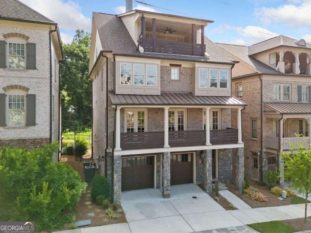Step into luxury living just minutes from downtown Atlanta and Buckhead in this beautifully crafted 5-bedroom, 5.5-bath single-family home located in the exclusive Enclave on Collier. This boutique John Wieland collection offers a gated, serene community filled with upscale amenities and timeless design. As you enter the home, you're greeted by an elegant foyer and easy access to the terrace level, where you'll find a bedroom with an ensuite bath, a kitchenette, and access to the covered patio and fenced backyard, perfect for guests, a private office, or multigenerational living. There is also a mudroom, and the garage is thoughtfully outfitted with a slat wall, extra shelving, and built-in storage to keep everything organized. Take the elevator (servicing ALL floors) or stairs to the main living level, where you'll find two spacious living rooms, one featuring built-in bookshelves flanking a cozy fireplace. The chef's kitchen is a showstopper with top-of-the-line stainless steel appliances, including a 6-burner Thermador range and microwave drawer, quartz countertops, an oversized island open to the keeping room and breakfast area, and a walk-in pantry with its custom wine rack. Also on this level: a guest bedroom, full hall bath, and a formal dining room/library that opens via three French doors to the full-length front porch overlooking an acre of greenspace. The owner's suite on the third floor includes a spa-like bathroom with a freestanding tub, dual vanities, two private water closets, and two custom closets with dressing areas. Two additional bedrooms complete this floor, each with an ensuite bath and a convenient laundry room. The fourth level offers a large media room with built-in speakers, tech closet, wine fridge, guest suite with full bath, and access to a sky terrace with fireplace, perfect for entertaining. Community amenities include gated entrances, a one-acre central park with a gathering pavilion and fireplace, and a neighborhood dog park. Located less than a mile from shopping and dining, Bitsy Grant Tennis Center, Bobby Jones Golf Course, the Atlanta BeltLine Northside Trail, and Atlanta Memorial Park.
