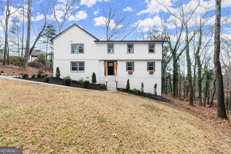 Located in established Kings Mountain neighborhood, within Marietta City limits. Just a few miles from the Marietta Square! This updated and well-maintained home comes with a crystal clear pool and multiple decks for entertaining. The lot is wooded and private. The interior of the home boasts 2 living/sitting areas, and a guest bdrm on the main. The kitchen is updated with white kitchen cabinets, quartz countertops, and bar seating. Hardwoods on the main level. Master features a vaulted ceiling with beams and has its own deck. The master closet is his/hers and the bath has a nice soaking tub. All new paint throughout the house.