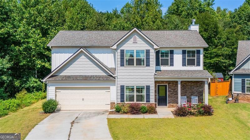 Welcome to this charming Craftsman-style home in the serene, gated community of Sutton's Landing featuring brand new Pickleball Courts and Swimming Pool. This BETTER THAN NEW Home has ample storage, a very private backyard and screens on all the windows. The front porch has features classic stacked stone which leads right into an open-concept layout. Arched doorways and a soft neutral palette create a warm, elegant atmosphere. The kitchen flows seamlessly into the main living area-perfect for entertaining or everyday living. The spacious master suite offers a peaceful retreat with a spa-inspired bath featuring a double vanity and a custom, floor-to-ceiling tiled shower with built-in shelving. Additional highlights include: Two extra storage closets-one in the downstairs hallway and one in the laundry room (not found in the new builds). Screens on all windows for added comfort. Updated soaking tub in the non-primary bath with custom tile and a built-in shelf. Enjoy tranquil evenings on your private, covered back porch surrounded by nature. This home blends timeless design with thoughtful upgrades-welcome home!