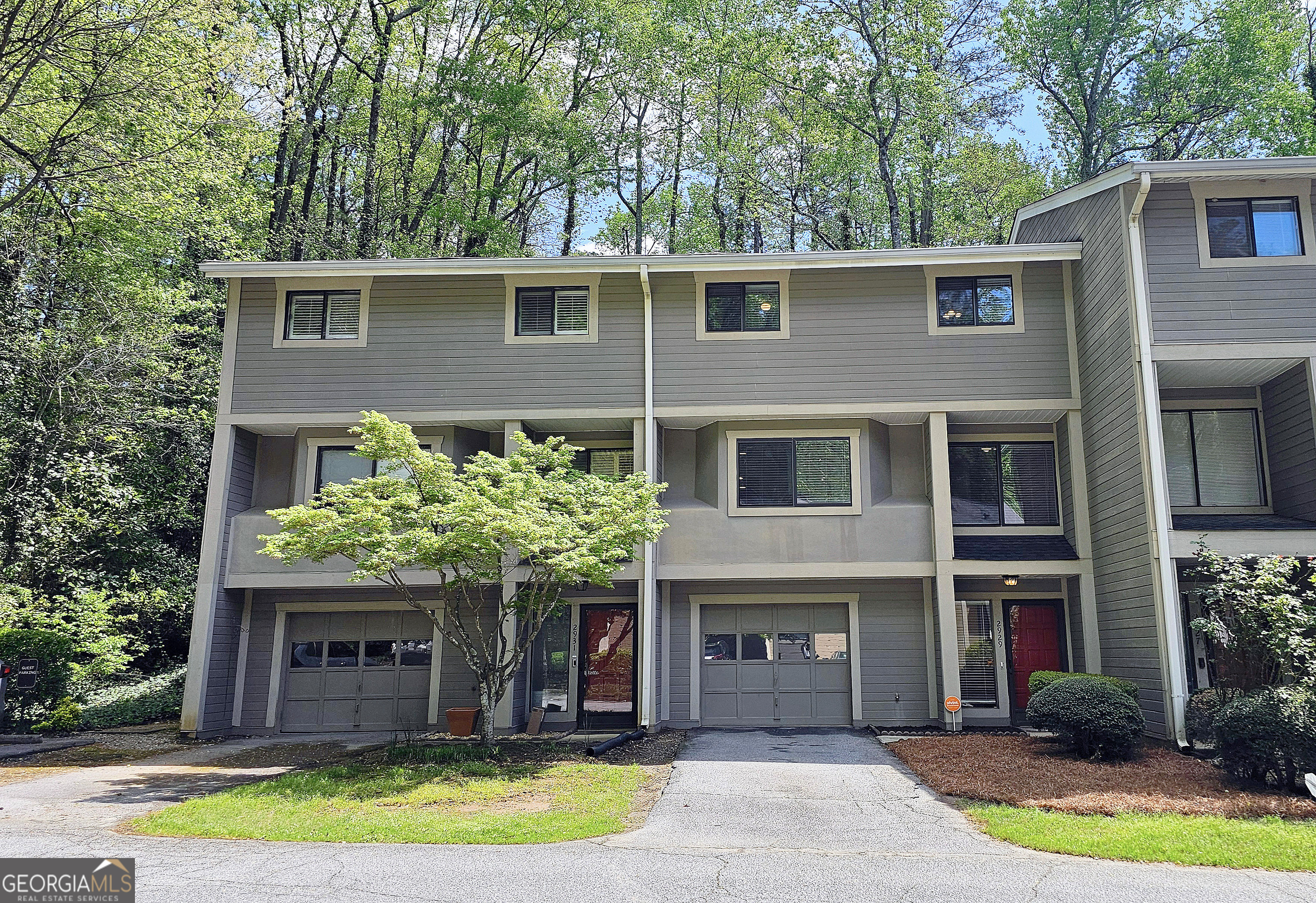 Charming Condo in The Sought-After Woods - Walk to The Battery! Discover this beautifully updated 3-bedroom, 2.5-bath condo in The Woods-one of the area's most desirable communities! This prime location offers walkability to The Battery, shopping, Greenways, and the Chattahoochee River, blending convenience with nature. Inside, you'll find new paint, hardwood floors, and a cozy wood-burning fireplace in the spacious living area. The eat-in kitchen and formal dining room provide plenty of space for entertaining. Step outside to a private patio overlooking serene wooded views-the perfect retreat. Additional features include a one-car garage and ample storage. Ideal for first-time buyers or investors, this home is a fantastic opportunity in a high-demand area. Don't miss out-schedule your showing today!