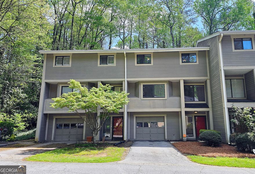 Charming Condo in The Sought-After Woods - Walk to The Battery! Discover this beautifully updated 3-bedroom, 2.5-bath condo in The Woods-one of the area's most desirable communities! This prime location offers walkability to The Battery, shopping, Greenways, and the Chattahoochee River, blending convenience with nature. Inside, you'll find new paint, hardwood floors, and a cozy wood-burning fireplace in the spacious living area. The eat-in kitchen and formal dining room provide plenty of space for entertaining. Step outside to a private patio overlooking serene wooded views-the perfect retreat. Additional features include a one-car garage and ample storage. Ideal for first-time buyers or investors, this home is a fantastic opportunity in a high-demand area. Don't miss out-schedule your showing today!