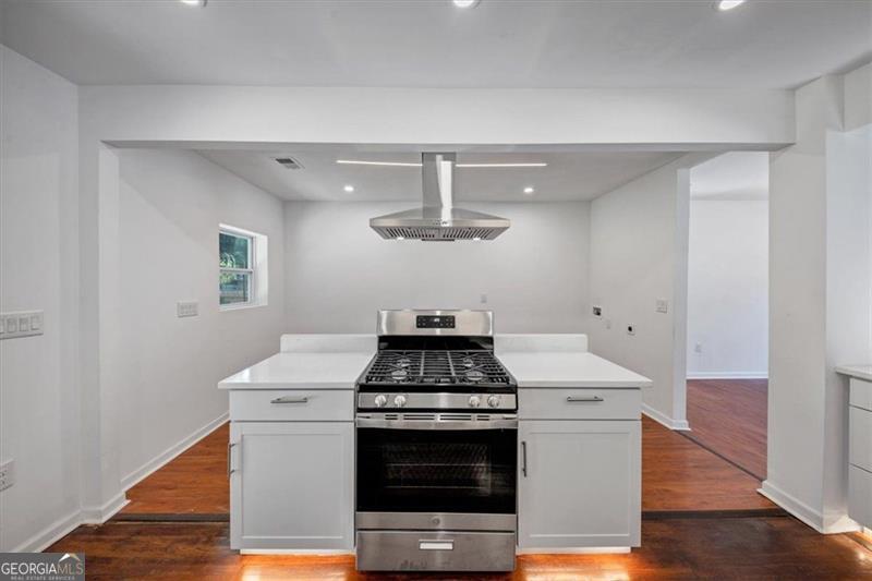 Discover a beautifully updated 3 BR / 2 BA ranch featuring 1,429 sq ft on a spacious 0.21-acre private lot. Built in 1953, this home blends charm with modern conveniences. Step inside to find a bright, open living area, a well-appointed kitchen highlighted by a center island and pantry, and cozy family room-all showcasing hardwood and carpeted floors. The home includes quality appliances, ample storage, and a thoughtfully designed layout with laundry facilities. Outside, enjoy a private, level yard complete with a gas grill, rear access, and parking for three. Comfort is ensured with central HVAC and ceiling fans throughout. Situated in the Wells neighborhood, you're mere minutes from downtown Atlanta and Hartsfield-Jackson Airport, with excellent schools nearby.