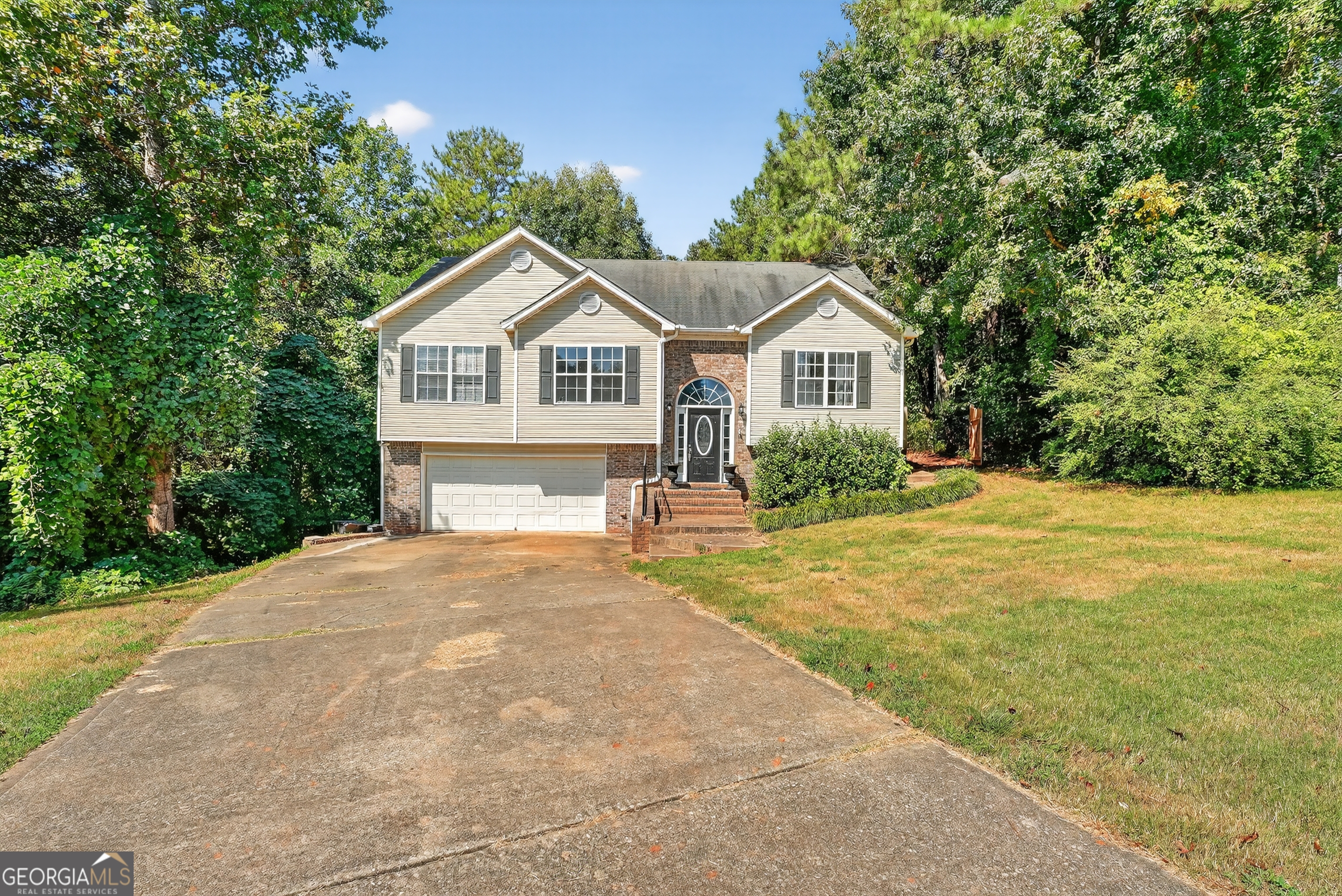 The perfect house to call home! This beautiful split foyer home boasts 5 bedrooms and 3 full baths! The entire interior has fresh paint and new laminate flooring in the kitchen, foyer, and baths. Well landscaped and at the end of a cul-das-ec, this secluded home sits on 3.4 ACRES! We are the lowest priced in the neighborhood on the largest lot, some touchups will turn this into a homey beauty. Great location and area of ATLANTA METRO. DON'T MISS IT, CALL TODAY!
