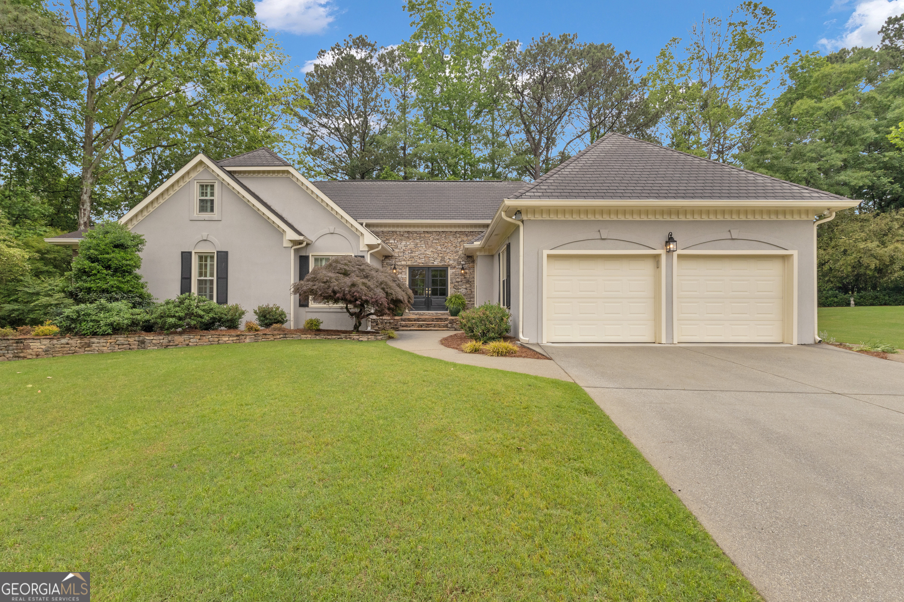 Huge price improvement! Don't miss this stunning home nestled on a cul-de-sac lot in the highly sought-after Sentinel West community with the added bonus of the ability to hike the gorgeous Kennesaw Mountain National Battlefield Park's trials from your back door! This is not your typical 4-bedroom, 4.5-bathroom home! With 2 primary suites and a suite on the upper floor and on the finished terrace level, it offers exceptional space and versatile living arrangements. The gracious foyer opens to a two-story family room and a large formal dining room. The light-filled kitchen features several work areas, ample cabinet space, a prep bar sink, and stainless steel appliances, and it opens to a spacious sunroom/family room. The sunroom boasts a vaulted ceiling with striking rafter details, a gas fireplace, built-ins, and access to a stone patio with a fireplace as well as a deck-perfect for entertaining! The main level also features two spacious primary suites-ideal for multigenerational living-as well as a cozy den and an office/flex space that could also be used as a nursery. There is a peaceful screened-in porch, perfect for a morning cup of coffee or an evening glass of wine. Upstairs, you'll find a charming bedroom, full bath, living area, and a separate bonus room-perfect for a craft room, playroom, or additional storage. The fully finished basement has everything needed for an in-law or guest suite, featuring a full kitchen, bedroom, bathroom, office, oversized living space with a fireplace, and its own garage access. The home's curb appeal is unmatched, with a park-like setting and a beautifully landscaped yard with stone exterior, walkways, and patios-so much to enjoy! This is truly a must-see home, perfect for both entertaining and everyday living. Sentinel West offers a community pool, tennis courts, and a playground. Schools of excellence and great proximity to restaurants & shopping!