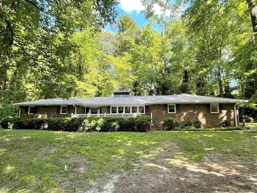 Park-like setting leads you to this all brick, beautifully renovated home situated on 1.2 acres. Enter the welcoming foyer that flows into a fabulous kitchen w/ great views of the long, tree lined driveway. Large living room and dining area, three bedrooms w/ spacious master that has walk-in closet and his/her vanities. Masonry fireplace w/ mantle in living room and breakfast area. Convenient mud/laundry room with plenty of cabinet space and also a half bath. Utility room leads to back yard. Large front patio, great for enjoying the outdoors. Call today!