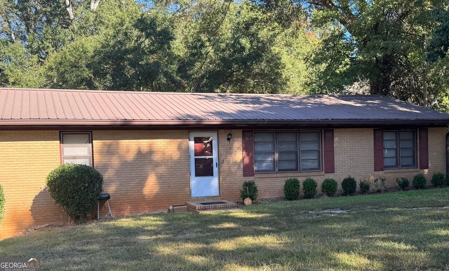 Solid 4-sided brick ranch offering true one-level living and great upside in a convenient Newnan location. This 3BR/2BA home has been used as a rental-livable as-is and primed for updates. Inside you'll find a comfortable living room, an eat-in kitchen, and a split secondary bedroom layout with a private primary suite. Outside, brick construction, simple rooflines, and a manageable yard keep ownership and maintenance straightforward. Ideal for investors or buyers looking to add sweat equity-bring your contractor and ideas and make it shine. Sold AS-IS.  Approx. 6-8 min to Downtown Newnan (Court Square), 10-12 min to Ashley Park with shopping/dining, 10-12 min to I-85 (Exit 47), 10-12 min to Piedmont Newnan Hospital, and about 35-40 min to Hartsfield-Jackson ATL.  Schedule your showing today!