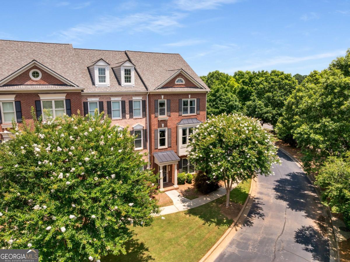 Natural light abounds this beautifully maintained 3-bedroom, 3.5-bath END-unit townhouse in the sought-after Westwood Park community in Alpharetta. This spacious home features a 2-car garage, hardwood floors on the main level, a light-filled family room with built-ins, new roof, and a separate den perfect with a vaulted stained wood ceiling. The kitchen features an island and lots of counter space making this kitchen a cook's kitchen. The open kitchen flows seamlessly to the outdoor deck-ideal for grilling and entertaining. The breakfast room and dining room offers multiple dining spaces. Upstairs, the oversized primary suite offers a walk-in closet, double vanity, and a separate tub and shower. A well-appointed secondary bedroom features a walk-in closet and an ensuite bathroom. Ease of laundry duties are accomplished with the laundry room conveniently located on the upper level. The 3rd bedroom and bath are located on the entry level providing privacy to guests. Enjoy resort-style amenities including a pool, fitness center, catering kitchen, and a stylish club room with a fireplace. All just minutes from Avalon, the Verizon Amphitheater, and top-rated North Fulton schools.