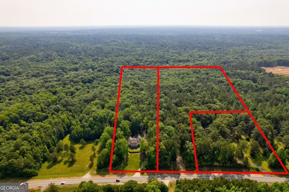 Wonderful Assemblage of 50 +/- Acres in prime location, only blocks from Trilith Studios. Imagine the possibilities of what can be done with this land. Land is being sold simultaneously with 539 Veteran Parkway and 551 Veterans Parkway. Currently zoned residential. This exceptional land is located in close proximity to a bustling commercial district. Within a short walk, you will find an array of shops, theatres, restaurants, hotels, and amenities that cater to the needs of residents and visitors alike. The presence of these commercial establishments adds convenience and accessibility to the area, making it an ideal location for various purposes. The excitement of all of the movies and TV shows being made within walking distance.