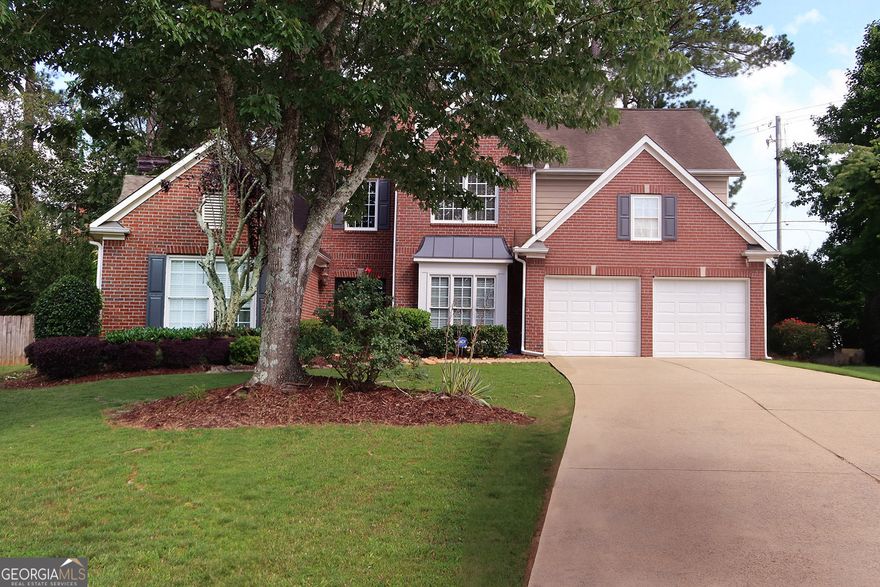 Discover the perfect blend of space, style, and location at 2720 Stillwater Lake Lane in Marietta. Tucked away on a quiet cul-de-sac in the sought-after Stillwater Lake community, this 5-bedroom, 4-bathroom home offers over 3,300 square feet of thoughtfully designed living space. The main-level owner's suite provides comfort and privacy, while the open-concept layout features a soaring two-story great room with a stunning wall of windows that floods the space with natural light and offers views of the private, fenced backyard. A double-sided fireplace connects the living area to a gourmet kitchen with a large island and double ovens-ideal for entertaining and everyday living. A second bedroom and full bath on the main floor add flexibility, while upstairs, three spacious bedrooms include a Jack-and-Jill bath and a private en-suite. Throughout, you'll find plenty of storage and little touches of character that set this home apart from cookie-cutter builds. The backyard patio offers a peaceful retreat perfect for relaxing or play. Walkable to the community pool, playground, and clubhouse, as well as nearby restaurants and schools, this home delivers the charm, convenience, and comfort you've been looking for!