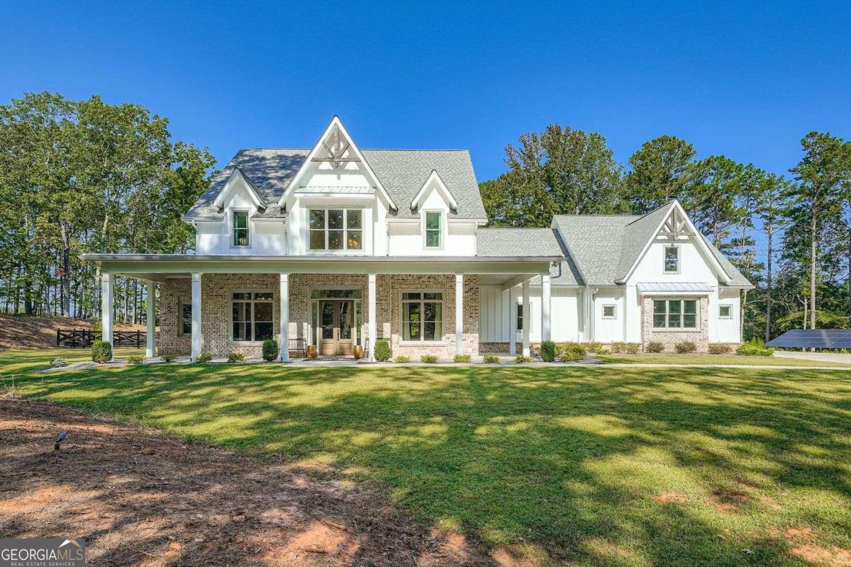 Welcome to your dream home on 5.5 private acres! This stunning 4-bedroom, 4 full and 2 half bathroom residence offers modern elegance and spacious comfort. Nestled at the end of a 600 foot long driveway on a beautiful tree lined street, this home boasts an open-concept living area with 12 foot ceilings on the main level, gleaming floors throughout, a gourmet kitchen featuring high end stainless appliances, granite countertops, and a enormous island perfect for entertaining. The primary suite on the main level is a true retreat with 17 feet cathedral ceilings, warm wood accents and its own screened patio. Each upper level bedroom has its own en-suite bath. 1800 square feet of covered outdoor space and an incredible turf surrounded pool and spa. Cross-buck wood fencing completes the private backyard. Large bonus/game room and so much storage in your walk-in attic space. Plenty of acreage to build a guest house, extra garage/workshop, or to store your RV or boat. The home boasts exceptional efficiency, designed to minimize environmental impact and reduce utility costs. Key energy-efficient features include spray foam insulation, solar panels, tankless water heater, energy efficient HVAC systems, appliances, and LED lighting. Additional highlights include a 3-car garage, storm room, energy-efficient windows, and smart home technology. Conveniently located near top-rated schools, shopping, and parks. Way too many custom features to list!