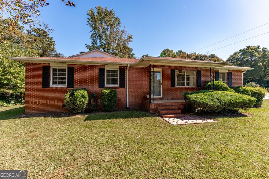 Charming 4-sided brick home with a spacious, fenced yard-perfect for both privacy and outdoor living. This versatile property includes a detached 2-car garage with a master suite above, offering flexible options for a master suite, guest suite, office, or rental space. Master suite has huge walk in master closet. Inside, hardwood floors and elegant French doors open to a covered patio, creating a seamless flow for entertaining. Ideally located just 1/2 mile from downtown Kennesaw and close to KSU, this home is perfect for those seeking convenience without the restrictions of an HOA.