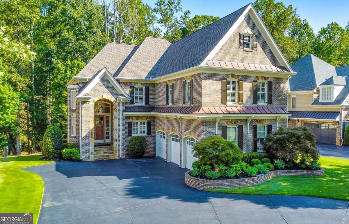 Discover the perfect family haven in a highly sought-after Marietta location! This meticulously maintained 4 bed / 4.5 bath four-sided brick and stone home sits on nearly half an acre in a quiet cul-de-sac, less than two miles from Marietta Country Club and Mount Paran Christian School. Step inside to discover a warm and inviting formal sitting and dining room, ideal for entertaining family and friends. The gourmet kitchen is a chef's delight, featuring Jenn-Air double ovens, a brand-new six-burner cooktop, a newer Bosch dishwasher, updated refrigerator, Pacific Trusteam vent hood, and granite countertops. The elegant keeping room boasts a coffered ceiling, built-in shelves, and a gas fireplace, with a bright sunroom just off the space - originally a screened-in porch that has been thoughtfully updated for year-round enjoyment. A main-level laundry room with sink, storage, and washer/dryer adds everyday convenience. Plantation shutters throughout add timeless elegance, while upgraded wrought iron spindles accent the staircase. The oversized upper-level primary suite features soaring ceilings and a sitting room with a gas fireplace. Relax in the spa-inspired primary bath that offers vaulted ceilings, two granite vanities, a jetted tub, shower, and a spacious custom closet with two separate sections. Three additional oversized bedrooms complete the upper level, with two sharing a bath offering separate vanity areas and one featuring its own ensuite. Wood floors extend throughout the main, upper, and finished basement levels, while tile flooring enhances the bathrooms. The finished basement is an entertainer's dream and includes a rec room with engineered wood flooring, a real brick accent wall, a bar with kegerator, wine fridge, and ice maker, plus a projector system with a screen and built-in entertainment center for the ultimate media room. This level also offers a full bath, bonus room, and ample storage. Step outside to enjoy the rear deck, covered lower patio with under-deck system, Zoysia lawn, and a charming pergola swing overlooking a serene wooded backdrop. Major component upgrades include upstairs/main HVAC replaced in 2020 with a warranty and Cool Air maintenance, and an ejector pump. A 4-zone sprinkler system and professional landscaping keep the grounds pristine. Additional highlights include a circular driveway, three-car garage, and a convenient path to the neighborhood tennis courts. This exceptional home combines comfort, convenience, and community, making it the perfect place to build lasting memories for years to come.