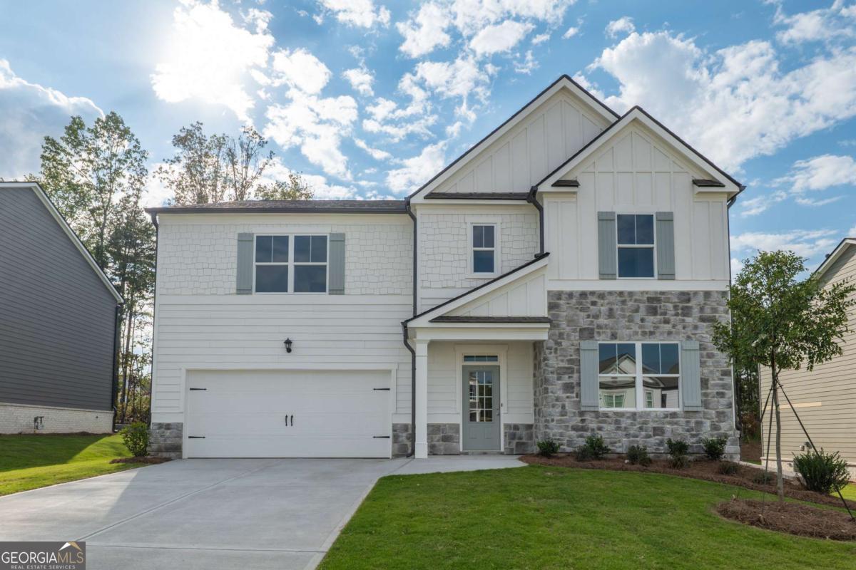 Discover a brand-new, never-lived-in home in the Carter Grove community, located just steps from Cartersville Primary School and the picturesque Woodland Hills Golf Course. Lawn care, brand new washer/dryer & smart home integration included! This energy-efficient floor plan offers a modern open-concept design, 5 generously sized rooms, three full bathrooms and expansive common areas. Washer, dryer, and refrigerator will be installed before move-in! The main level features a versatile bedroom and full bathroom, perfect for guests or a home office. Enter the kitchen to find sleek white cabinetry, granite countertops, and a spacious island flowing into the inviting family room, accented by a gas fireplace. Upstairs, a generous loft awaits, ideal for entertainment, alongside three more bedrooms in addition to the lavish, oversized primary suite, complete with a huge sitting room. The primary bathroom impresses with double granite vanities, a large tub with separate shower, and two large walk-in closets. Cartersville is a vibrant community that thrives with nearby parks and recreation, with the esteemed Woodland Hills Golf Club, an 18-hole course with affordable memberships, just moments away. Enjoy Carter Grove's top-tier amenities, including a clubhouse, two tennis courts, six pickleball courts, dog park and a picnic area, with exciting new additions planned. The newly landscaped, level backyard is perfect for relaxation, and Cartersville Primary School's proximity ensures a safe, walkable route for kids. Sports lovers are minutes from LakePoint Sports, a 1,300-acre hub with a 170,000-square-foot Champions Center, Major League-sized baseball fields, multi-use fields, a beach volleyball pavilion, and a wakeboarding park. A must-see, move-in-ready masterpiece!
