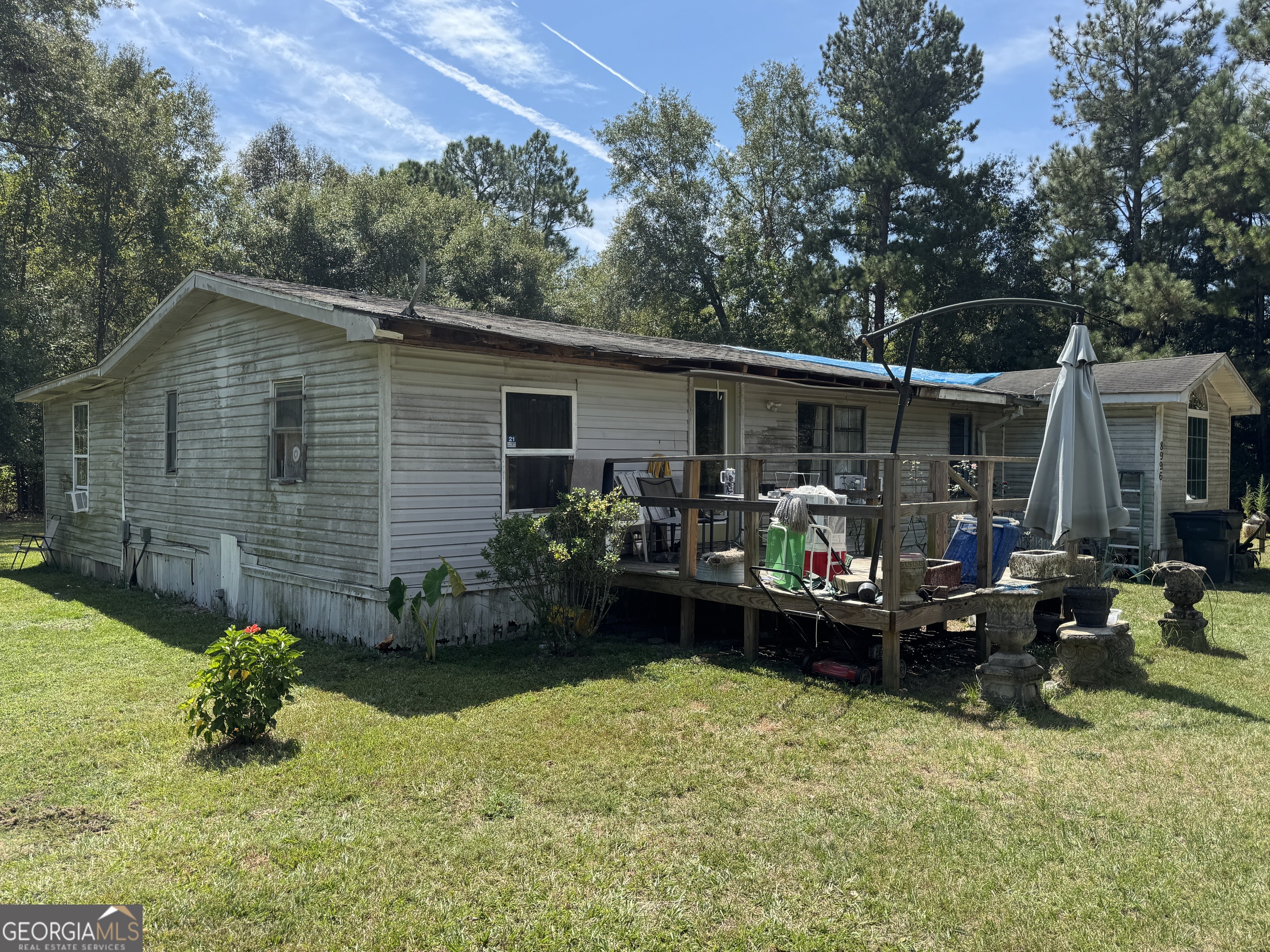 This 3 bedroom, 2 bath mobile home sits on 1.61 acres in a quiet rural setting, just 3 minutes from I-16, 5 minutes to downtown Metter, and about 15 minutes from Statesboro. The home offers a split floor plan with a deep well, septic system, and multiple small outbuildings for storage and utility use. The main home is a 1989 Destiny model (24x40) with central heating and air equipment on site. At present, the system isn't hooked up, but window units are in place for cooling. Most of the flooring has been removed (except in the living room and kitchen), exposing the subfloor and making it ready for new carpet of your choice. Outside, the property includes a 10x20 utility building, a pole shed, and a small pre-fab storage shed-great for tools, lawn equipment, or hobby use. Power is provided through EMC, and internet service is available through Pineland telephone at the location. This is a fixer-upper being sold as-is, where-is, and it will need some attention. But with the land size, location, and basic infrastructure already in place, it's a solid opportunity for someone looking for an affordable home they can improve, or for an investor seeking a rental or flip project.