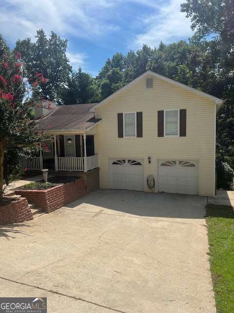 Welcome to 5325 High Point Road in Flowery Branch, where charm meets convenience in the award-winning Cherokee Bluff school district. The easy-to-maintain yard with a gentle slope leads to a welcoming front porch, setting the stage for the warmth inside. Step into the living room, centered around a wood-burning fireplace, and flow into the updated kitchen with granite countertops, stainless steel appliances, an eat-in dining area, and abundant cabinet storage. This split-level home features LVP flooring throughout, blending style and durability. Upstairs, you'll find the spacious primary suite with a relaxing garden tub, plus two generous secondary bedrooms and a second full bath, both with tile floors and updated vanities. The lower level adds versatility with a laundry room, garage access, and a bonus flex space perfect for a workout room, home office, or playroom. Outdoors, enjoy the privacy of a wooded backdrop from your deck, with no HOA restrictions limiting your lifestyle. Practical updates include an HVAC system less than 10 years old and a water heater just one year old. Roof approx. 12 yrs w/Architectural shingles in great shape. Beyond the home itself, the location is unbeatable-minutes from Spout Springs Village shopping and dining, close to I-985, the Falcons training facility, the Braselton hospital system, and just a short drive to Lake Lanier and historic downtown Flowery Branch. With its upgrades, location, and pricing, this home is move-in ready and waiting for its next chapter to begin.