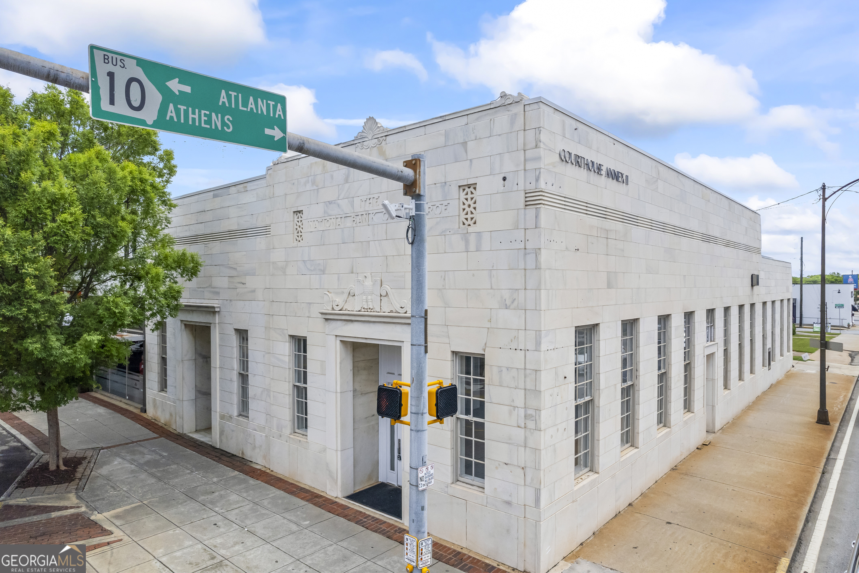 Prime Downtown Monroe Opportunity - Historic 100 N Broad Street! Positioned at the heart of Downtown Monroe's most iconic intersection-Broad and Spring Streets-100 N Broad Street offers nearly 5,000 square feet of space ready to be reimagined into a showpiece destination. This premier corner location places you at the epicenter of all downtown events, with maximum visibility, foot traffic, and historic charm. Originally constructed as The National Bank of Monroe, the building retains several original vaults-an architectural feature that tells a story while offering a unique design element rarely found in modern spaces. Soaring ceilings, grand windows, and rich stonework evoke a timeless elegance, offering the perfect canvas for a luxury retail experience, high-end restaurant, gallery, or curated professional office. Whether you're looking to invest in one of Monroe's most storied properties or bring a bold new concept to life in a thriving downtown district, this iconic space invites creativity, sophistication, and presence!