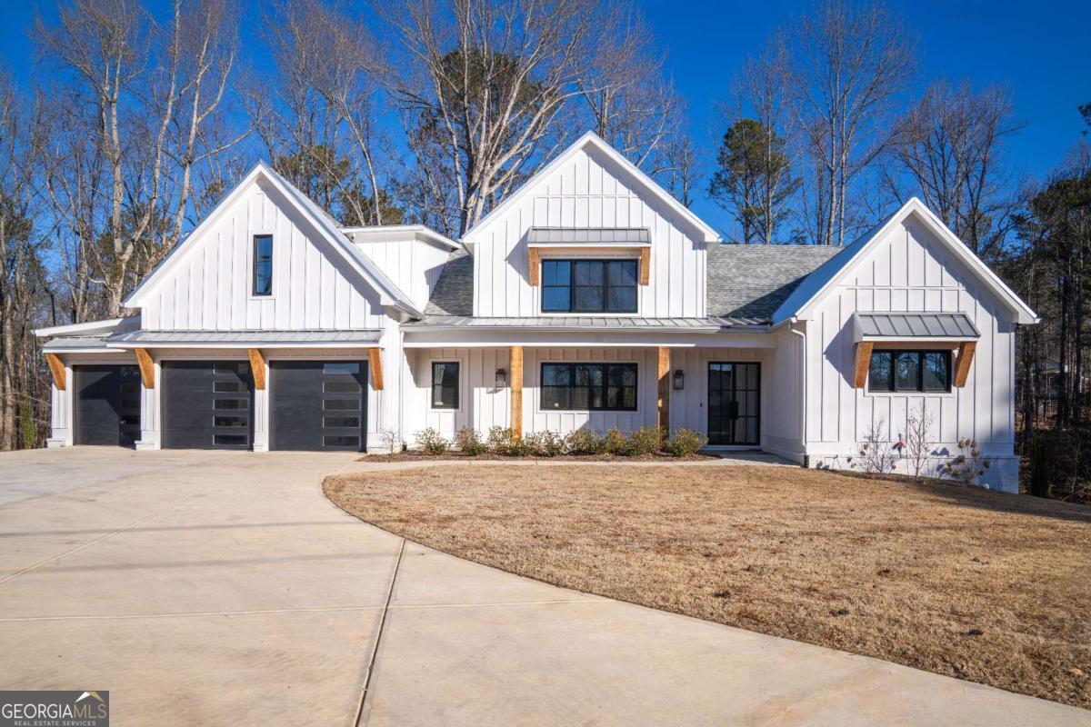 Welcome to this breathtaking modern farmhouse, where luxury meets functionality. With high ceilings, an open floor plan, and designer  finishes throughout, this home offers the perfect blend of elegance and comfort. The expansive kitchen is a chef's dream, featuring high end appliances, a massive island, and a hidden walk-in pantry. The owner meticulously selected premium materials, investing $250,000 in  custom upgrades to elevate every detail of this home. Unwind in the spa-like primary suite, complete with a steam shower and a massive  walk-in closet. The finished basement boasts beautiful marble-finished baths, perfect for guests or additional living space. Outdoor living is  just as spectacular, with a half kitchen on the deck, ideal for entertaining. A three-car garage and 2.48 acres of serene land provide both  space and privacy. This recently appraised home offers approximately 7,700 sq. ft. of finished living space and is truly one of a kind. Don't  miss this rare opportunity!