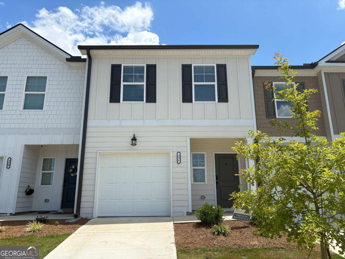 Welcome to this beautifully maintained, nearly new 3-bedroom, 2.5-bath townhome located in one of Hoschton's most desirable swim communities! Designed with comfort and style in mind, this townhome features a bright, open-concept layout that seamlessly connects the family room, dining area, and kitchen-perfect for entertaining and everyday living. The kitchen is a standout, boasting granite countertops, a spacious center island, stainless steel appliances, and a large pantry. State-of-the-art flooring runs throughout the main level, adding a touch of elegance and durability. Upstairs, the oversized master suite impresses with a spacious walk-in closet, a separate soaking tub and shower, and generous space for relaxing. Two additional bedrooms are thoughtfully positioned on the opposite side of the townhome for added privacy, and the convenient upstairs laundry closet makes chores a breeze. Step outside to your private patio-ideal for outdoor dining, grilling, or simply unwinding. The community is perfect for walking, jogging, and enjoying the outdoors, with a refreshing pool just down the street. Hoschton offers the best of both worlds: small-town charm with big-city convenience. Enjoy nearby shopping, dining, and entertainment, all within easy reach of Atlanta. Don't miss this exceptional opportunity-schedule your tour today!