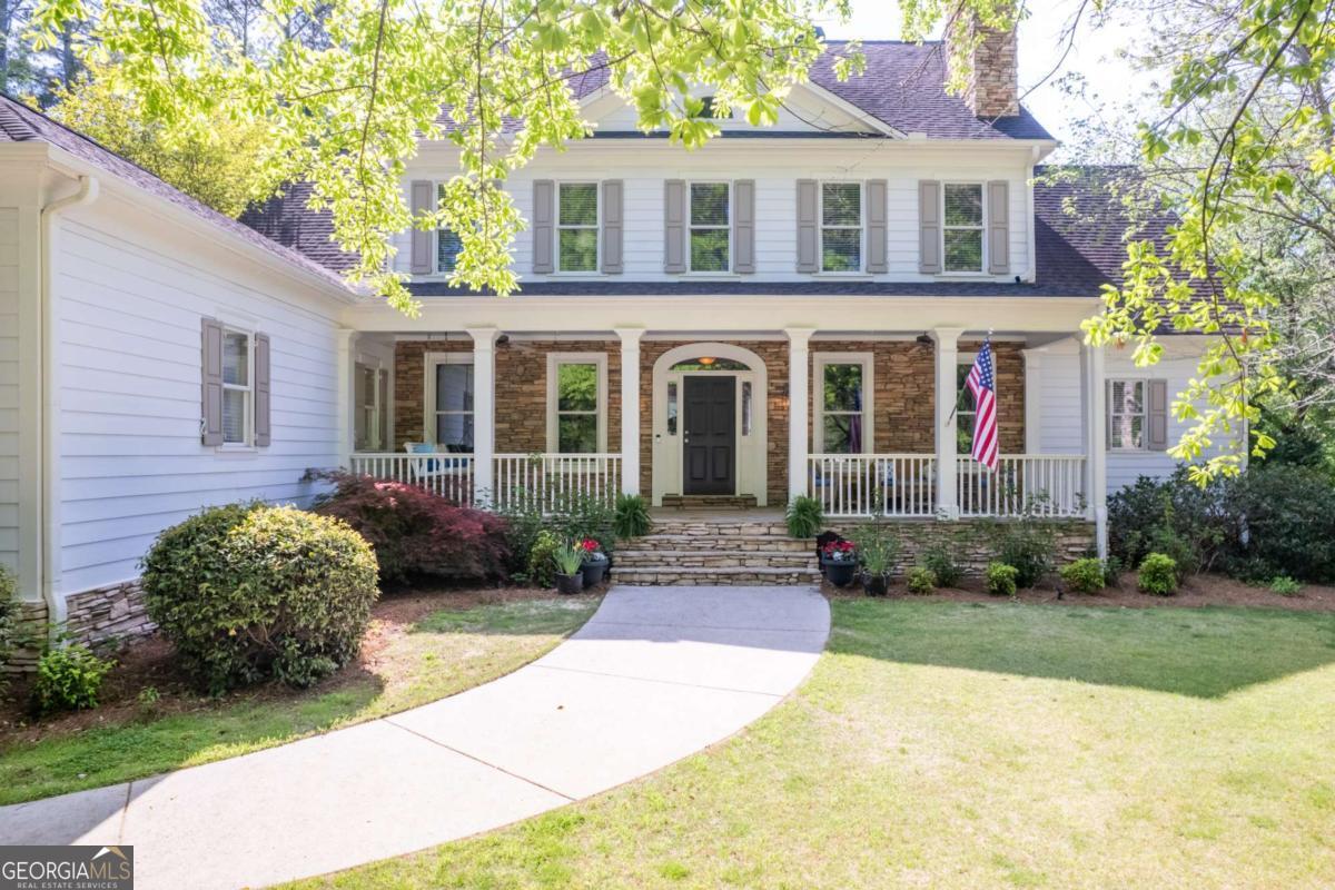Experience refined country living in this bespoke craftsman farm-style mini-estate located in the Milton School district and nestled on 1.4 acres of tranquil, partially wooded land in Milton. Boasting over 5,400 square feet across three exquisitely finished levels, this private sanctuary offers the freedom to expand, create, and enjoy the lifestyle of your dreams. Step into a main-level oversized primary suite with French doors opening to a sprawling patio overlooking a dazzling, resort-style saltwater pool-perfect for morning coffee or peaceful sunset evenings. Four additional bedrooms- including a second primary with ensuite-and two full baths await upstairs. The fully finished walk-out terrace offers two private entrances, a flexible sixth bedroom/office suite, a spacious great room, exercise area, media lounge, and a workshop that easily transforms into a craft studio, garden haven, or storm shelter. Flooded with natural light, the grand two-story great room features dramatic 20+ foot ceilings, custom built-in shelves, and a stone wood-burning fireplace-ideal for intimate gatherings or festive entertaining. At the heart of the home, the gourmet kitchen dazzles with a Wolf gas cooktop, Thermador appliances, granite countertops, and a striking island under designer lighting. Entertain effortlessly with an open-concept dining and keeping room, wet bar with wine cooler, and easy flow onto the expansive deck with panoramic views of the lush, fenced backyard and sparkling pool. Embrace year-round outdoor living-invite friends to the wide, dual-sitting front porch or host unforgettable pool parties in the naturally landscaped backyard, accessed directly from both the kitchen and the master suite as well as the finished terrace level. Newer paint inside and out, hardwood flooring, luxurious triple crown molding, and carpeted bedrooms add elegant touches throughout. With no HOA, a fully fenced yard, ample storage, and versatile private entrances, this estate offers comfort, privacy, and endless possibility-ready for cherished memories and new adventures. Don't miss your chance to own this idyllic Milton retreat.