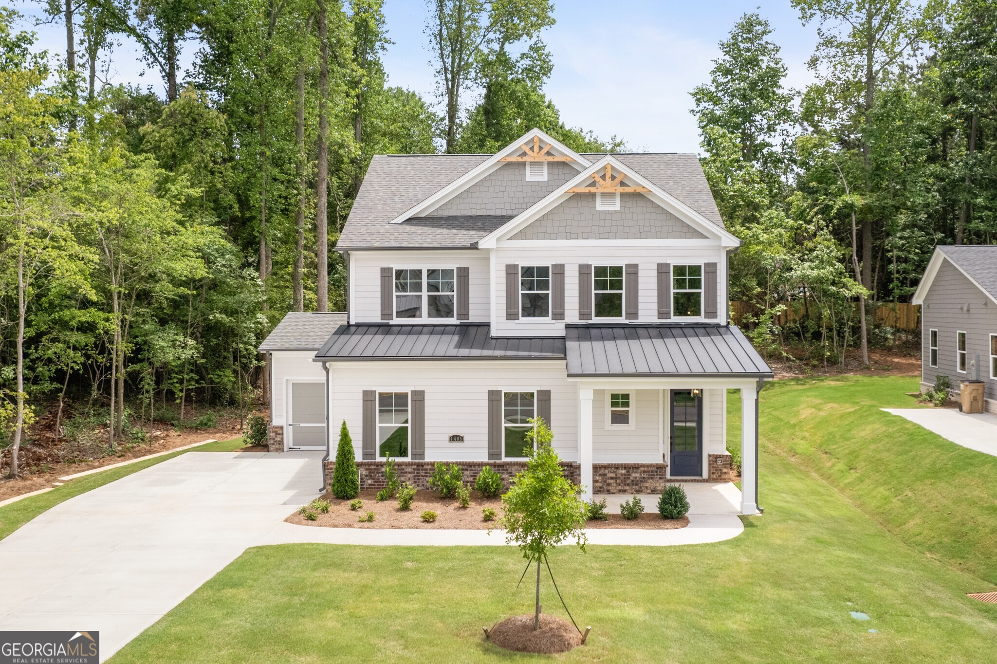 The Manor plan built by Peachtree Residential. Quick Move in! Welcome home to your lake country retreat! This beautiful 4 bedroom, master on main home will wow you inside and out. You are immediately greeted by a large 2-story foyer entry. At the rear you will find the magnificient chef's paradise kitchen outfitted with beautiful tile backsplash, hood vent, and a massive island overlooking the cozy family room with built in cabinets/bookshelves flooded by bright, natural light from the sliding patio door. The spacious master on main suite is accompanied by a spa-like bathroom with massive frameless glass shower. Upstairs you will find a sizeable loft and three secondary bedrooms that could almost serve as another primary suite. Out back is your summertime wonderland perfect for relaxation and cooking up some meals. The covered patio provides room for a nice shaded dining area and the grilling patio is ready for you to get your bbq & grill master experience on. You don't want to miss this amazing opportunity in one of Lake Lanier's most serene communities! Call today!