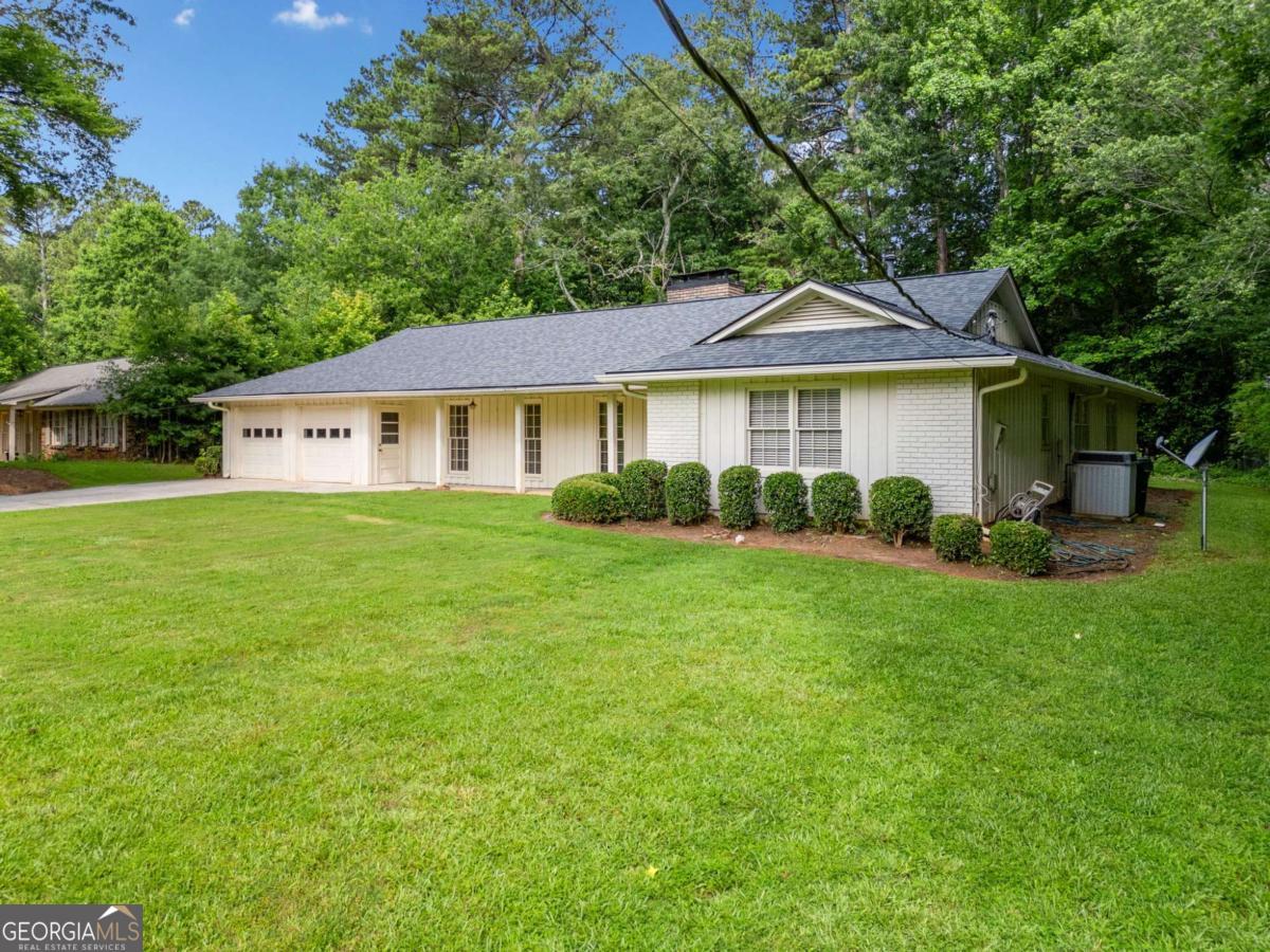 Amazing find in a terrific East Cobb neighborhood. Needs a little love and updating, but the bones are so good! This sprawling ranch floorplan has beautiful hardwood flooring throughout living room, dining room, family room, kitchen and breakfast nook. Tile and vanities in both bathrooms. Kitchen has lots of cabinet space and countertops have been updated to granite. Formal dining room opens to the living room, spacious family room with fireplace and built in bookshelves. Expansive back porch is screened in and overlooks private backyard with scenic woods. Pope School Districk. Great East Cobb location, so close to Johnson Ferry. You won't want to miss the opportunity to update this one to your liking and will appreciate that it's priced accordingly.