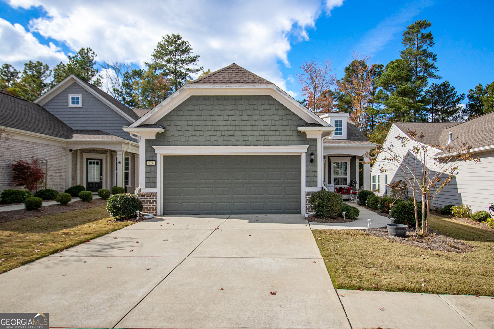 Welcome to this beautiful 2-bedroom, 2-bathroom home located in the highly sought-after Sun City Peachtree 55+ Adult Community! The inviting front porch welcomes you with warmth and charm, giving you a sense of home before you even step inside. Upon entering, you'll be greeted by an open floor plan that offers seamless flow throughout. The spacious kitchen features expansive granite countertops, upgraded stainless steel appliances, and a stunning "knock knock" refrigerator that adds a touch of sophistication. Custom plantation blinds adorn every window, and each room boasts unique lighting to enhance the atmosphere. The entryway highlights hand-scraped hardwood floors that extend from the foyer through to the kitchen, adding elegance and warmth to the home. For added peace of mind, a Ring doorbell system with accompanying cameras and monitor ensures you can see who is approaching your door before they even ring the bell. Step outside to the back lanai, a perfect spot to read a book, enjoy a cup of coffee, or simply unwind. Whether you're relaxing at home or enjoying the expansive amenity center and abundant activities in the community, this home offers the ideal blend of comfort and convenience. Don't miss out on this incredible opportunity to live in a vibrant 55+ community that offers a vibrant lifestyle with world-class amenities including golf, indoor and outdoor swimming, recreational clubs, pickleball, tennis, scenic golf cart paths, and breathtaking views. Experienced the best of active adult living - Schedule your showing today!
