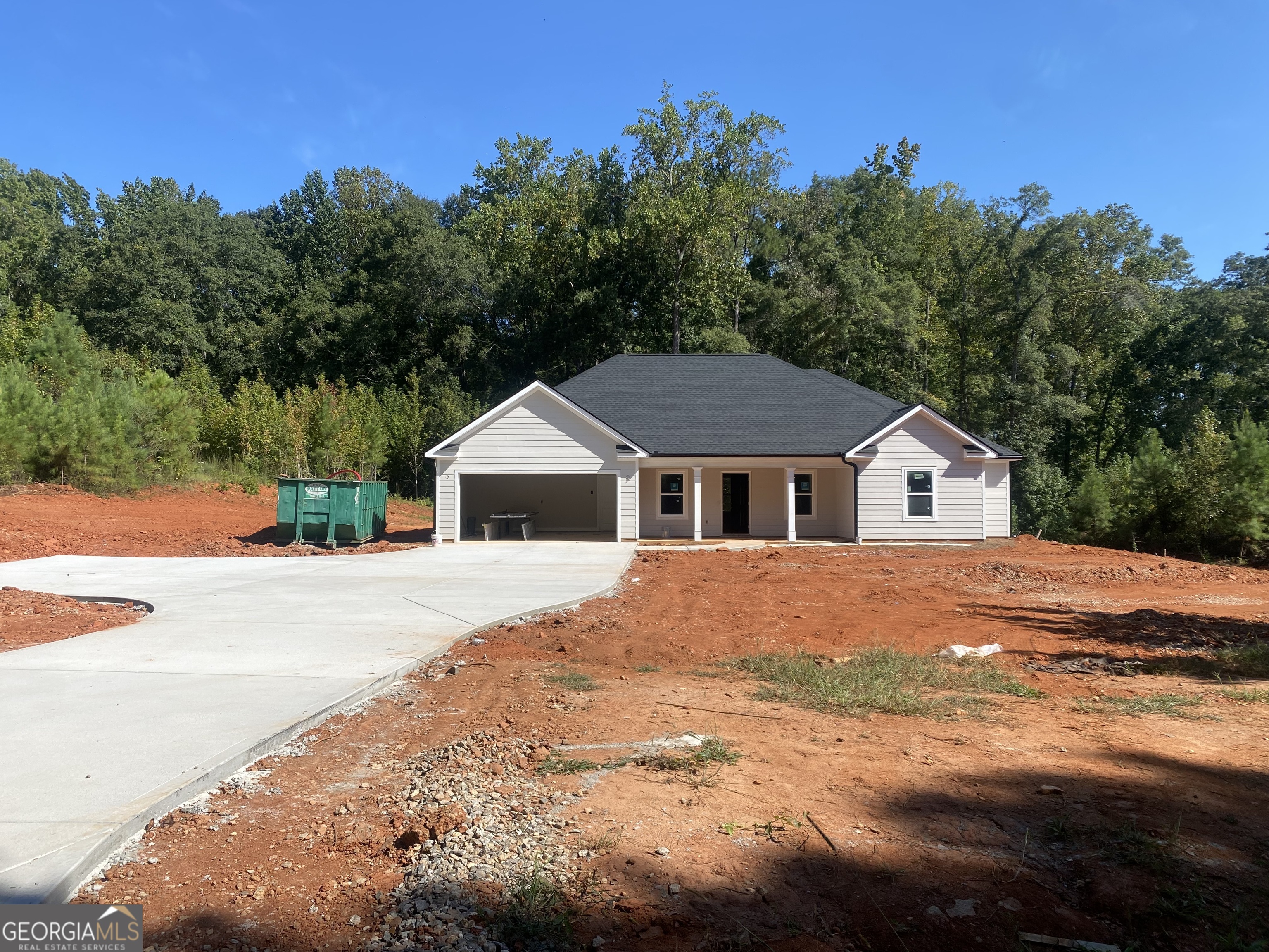 New construction ranch in rural Upson County/Yatesville on a beautiful 3.1 +/- acre lot away from it all! Offering 4 bedrooms and 2 full baths in a one story ranch floorplan, the home features all 4 bedrooms on the main level in a split bedroom plan. Living areas include a family room, designated formal dining area, and a nice island kitchen, all in an open floorplan for easy living and gathering! The kitchen features stainless steel appliances, real wood kitchen cabinetry with soft close hinges, a great island with storage and built in trash cans, and granite countertops with a tile backsplash. Great split bedroom layout with the primary suite on one side and a hall with the secondary beds and bathroom on the opposite side of the home. All secondary bedrooms feature walk-in closets and one bedroom has a vaulted ceiling! The primary suite features a vaulted ceiling, walk in closet, large vanity with granite countertop, linen closet, and oversized walk in full tile shower. Other features include a spacious laundry room, 2 car garage with automatic openers, LVP hardwood look flooring throughout, crown molding in the dining and family room, LED lighting throughout, and granite in the kitchen and both bathrooms. The exterior is constructed of sturdy Hardie siding and offers a lifetime architectural roof. Enjoy the peace and quiet from the covered front porch or overlook the yard and rear woods with a creek from the covered rear patio with ceiling fan. Both porches have with rustic wood planked ceilings. High speed fiber internet is available through Conexon! Quiet road with very little through traffic in a quiet part of Upson County just outside of downtown Yatesville. Very convenient to Hwy 74 for easy access to Thomaston, Forsyth, and Macon. Use the preferred lender and receive 1% of the loan amount back to use towards closing costs and/or interest rate buy down! Home can close within 30-40 days from time of list.