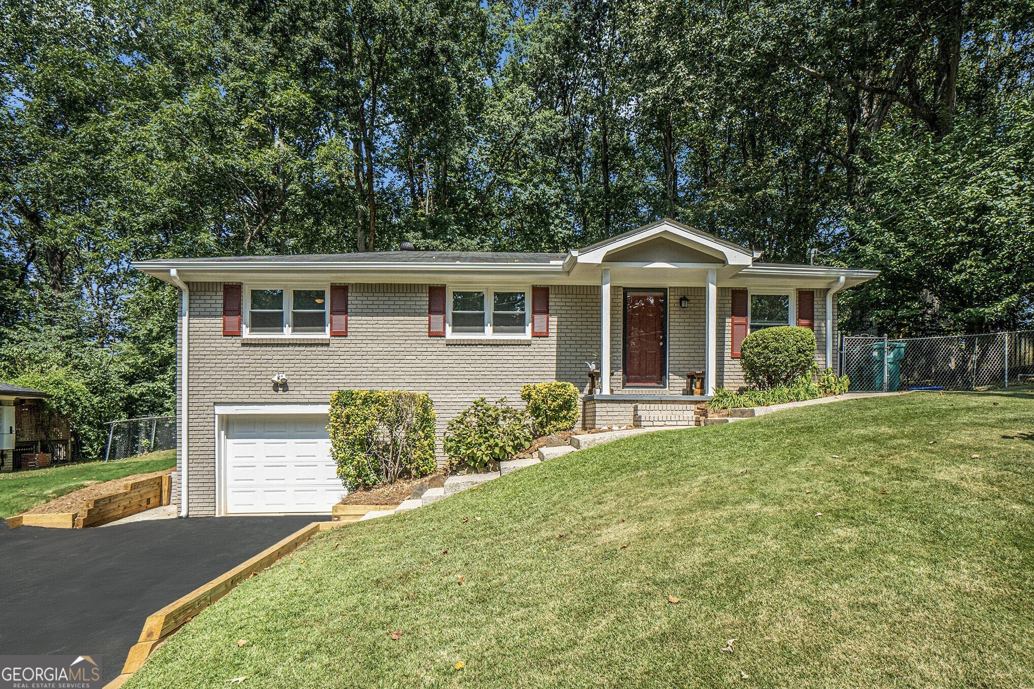 Amazing Opportunity in the Heart of Smyrna! Just Minutes from Smyrna Market Village, Cobb Park, Silver Comet Trail, The Atlanta Braves Stadium at The Battery, Shops, Restaurants, Schools, and Entertainment, this location makes Everyday Living a Breeze. Step inside this Charming Brick Ranch to find Hardwood Floors and an Open Living Space that flows seamlessly into the Eat-In Kitchen. The Kitchen features a Large Island with Granite Countertops, White Shaker Cabinets, Stainless Steel Appliances, and Views to the Living Room perfect for Everyday Living and Entertaining. The Primary Bedroom includes a Private Ensuite Half Bathroom, while Two Additional Bedrooms share an Updated Full Hall Bath with a Shower-Tub Combo. A Spacious Bonus Room on the Lower Level offers endless possibilities use it as a Bedroom, Playroom, Media Room, Home Gym, or whatever best fits your Lifestyle. Enjoy the convenience of a One-Car Garage and Driveway Parking. Outside, the Backyard offers a Massive Flat Grassy Space ideal for Play, Gardening, Grilling, and Hosting Gatherings. All this within Walking Distance to Smyrna Village and just 10 Minutes from The Battery Atlanta. With Easy Access to Parks, Shops, Dining, and Major Highways, this Standout Home perfectly balances Tranquil Suburban Living with Ultimate City Convenience. Don't Miss Your Chance to Make this Beautiful Smyrna Home Yours!